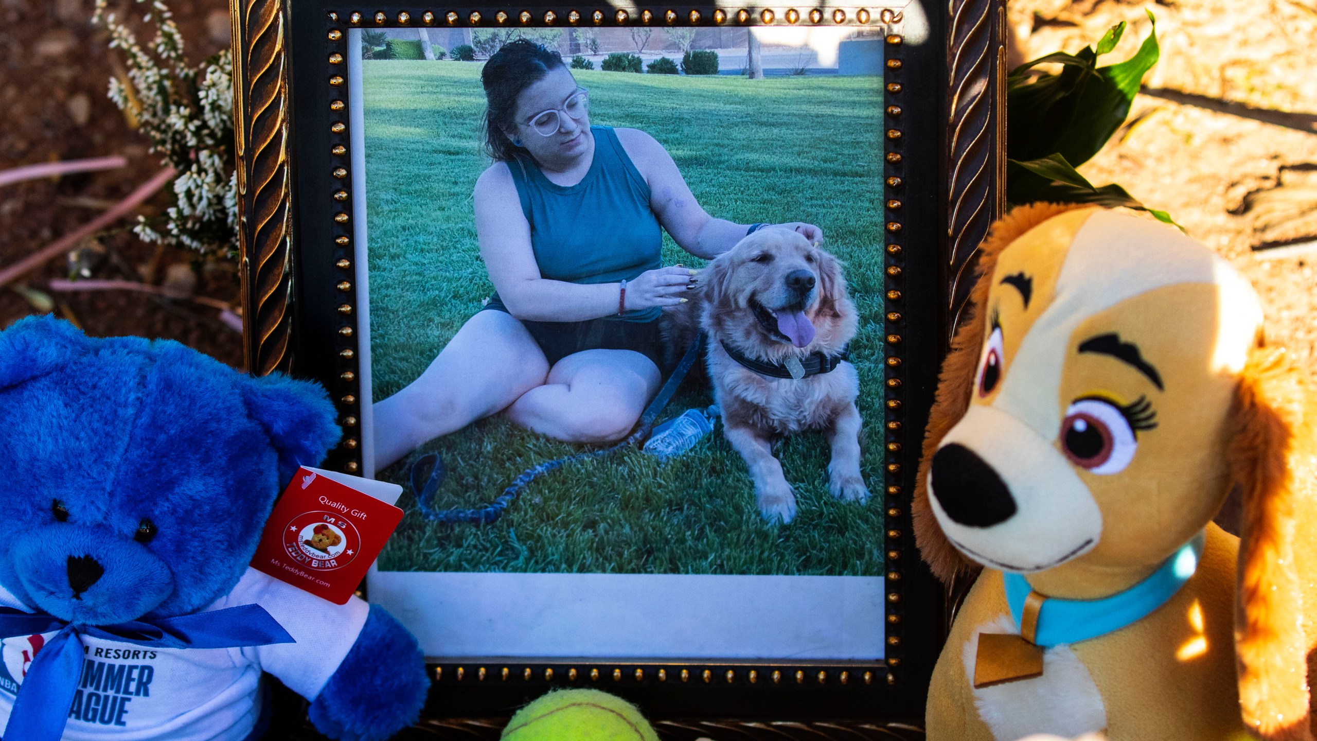 A photography of Tina Tintor, 23, and her dog is placed at a makeshift memorial site to honor them at South Rainbow Boulevard and Spring Valley Parkway, on Thursday, Nov. 4, 2021, in Las Vegas. Tintor and her dog were killed when Raiders wide receiver Henry Ruggs, accused of DUI, slammed into the rear of Tintor's vehicle. (Bizuayehu Tesfaye/Las Vegas Review-Journal)