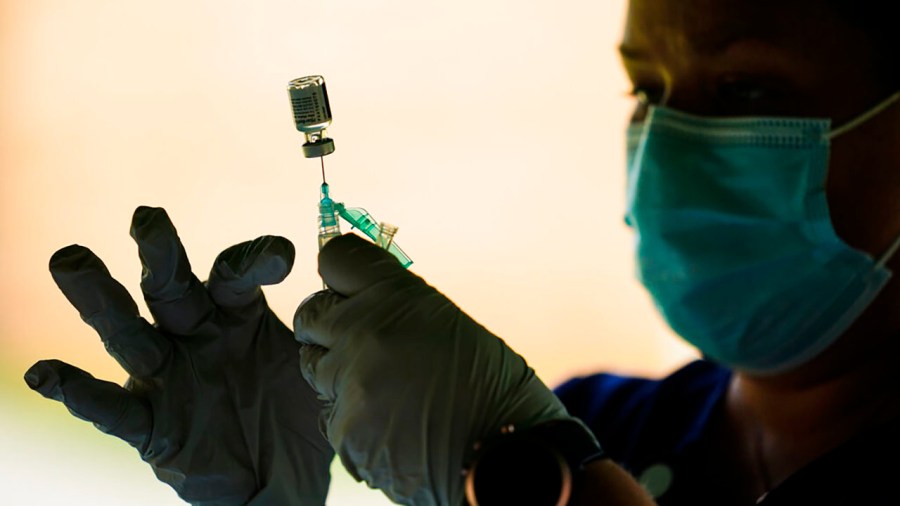 In this Sept. 14, 2021, file photo, a syringe is prepared with the Pfizer COVID-19 vaccine at a clinic at the Reading Area Community College in Reading, Pa. (AP Photo/Matt Rourke, File)