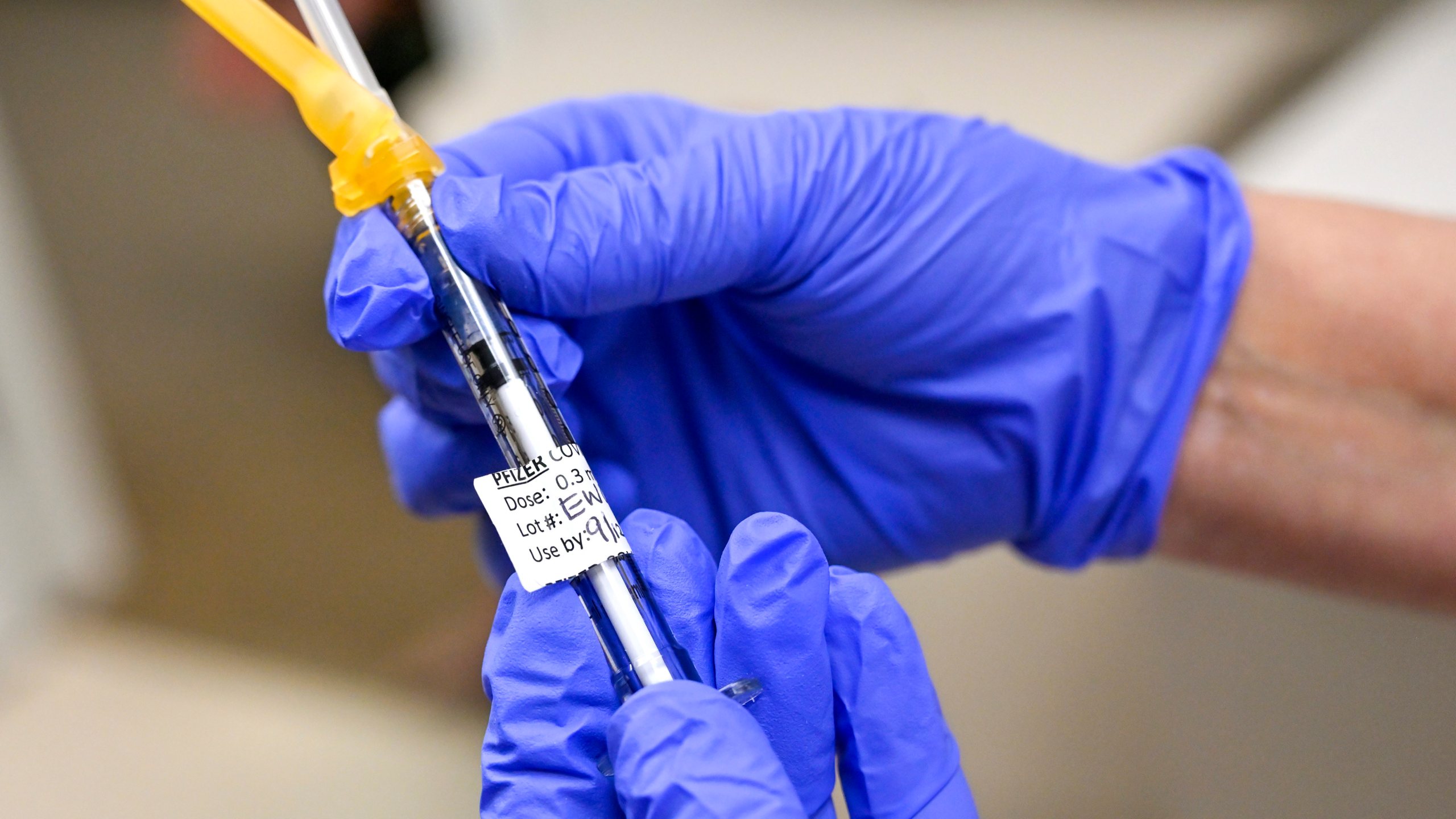 Nurse Mary Ezzat prepares to administer a Pfizer COVID-19 booster shot to Jessica M., Thursday, Aug. 19, 2021, at UCI Medical Center in Orange, Calif. (Jeff Gritchen/The Orange County Register via AP)