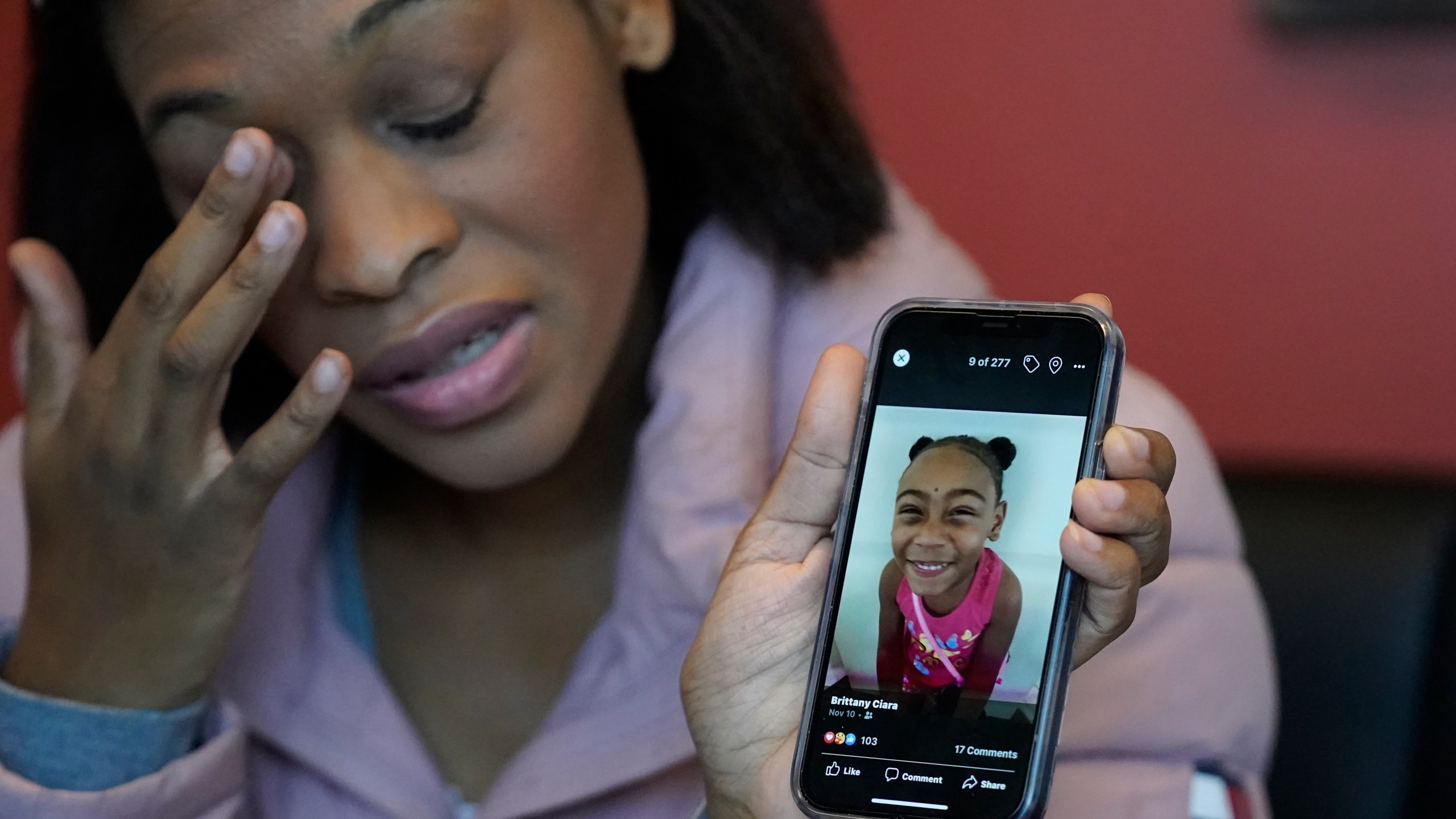 Brittany Tichenor-Cox, holds a photo of her daughter, Isabella "Izzy" Tichenor, during an interview Monday, Nov. 29, 2021, in Draper, Utah. Tichenor-Cox said her 10-year-old daughter died by suicide after she was harassed for being Black and autistic at school. She is speaking out about the school not doing enough to stop the bullying. (AP Photo/Rick Bowmer)