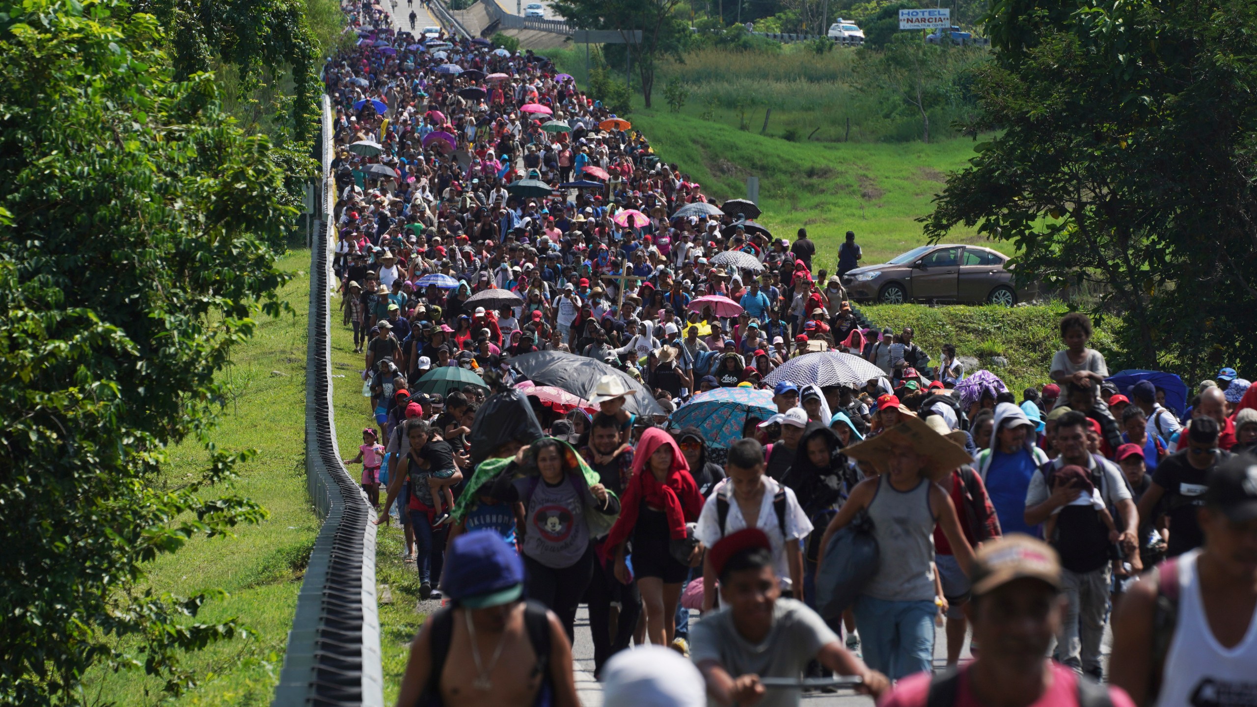 Migrants arrive in Villa Comaltitlan, Chiapas state, Mexico, Oct. 27, 2021, as they continue their journey through Mexico to the U.S. border. The Biden administration struck agreement with Mexico to reinstate a Trump-era border policy next week that forces asylum-seekers to wait in Mexico for hearings in U.S. immigration court, U.S. officials said Thursday. (AP Photo/Marco Ugarte, File)