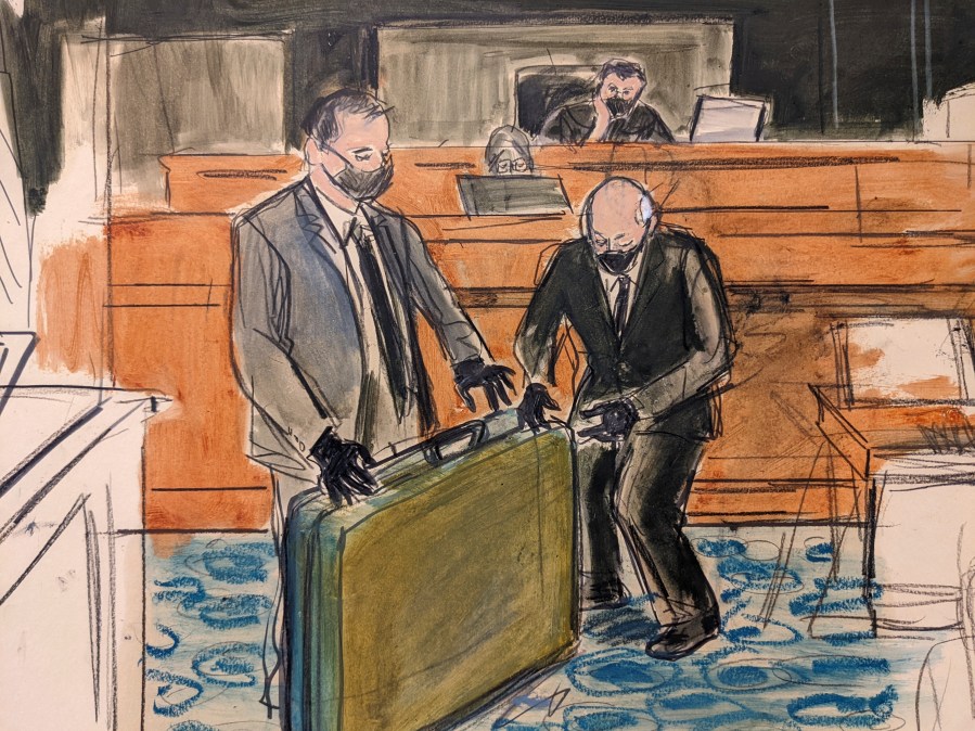 In this sketch, a prosecution detective, left, shows a massage table recovered from Jeffrey Epstein's Palm Beach Beach home to witness and former Palm Beach Police Officer Gregory Parkinson, right, during testimony in the sex-abuse trial of Ghislaine Maxwell on Dec. 3, 2021, in New York. (Elizabeth Williams via AP)