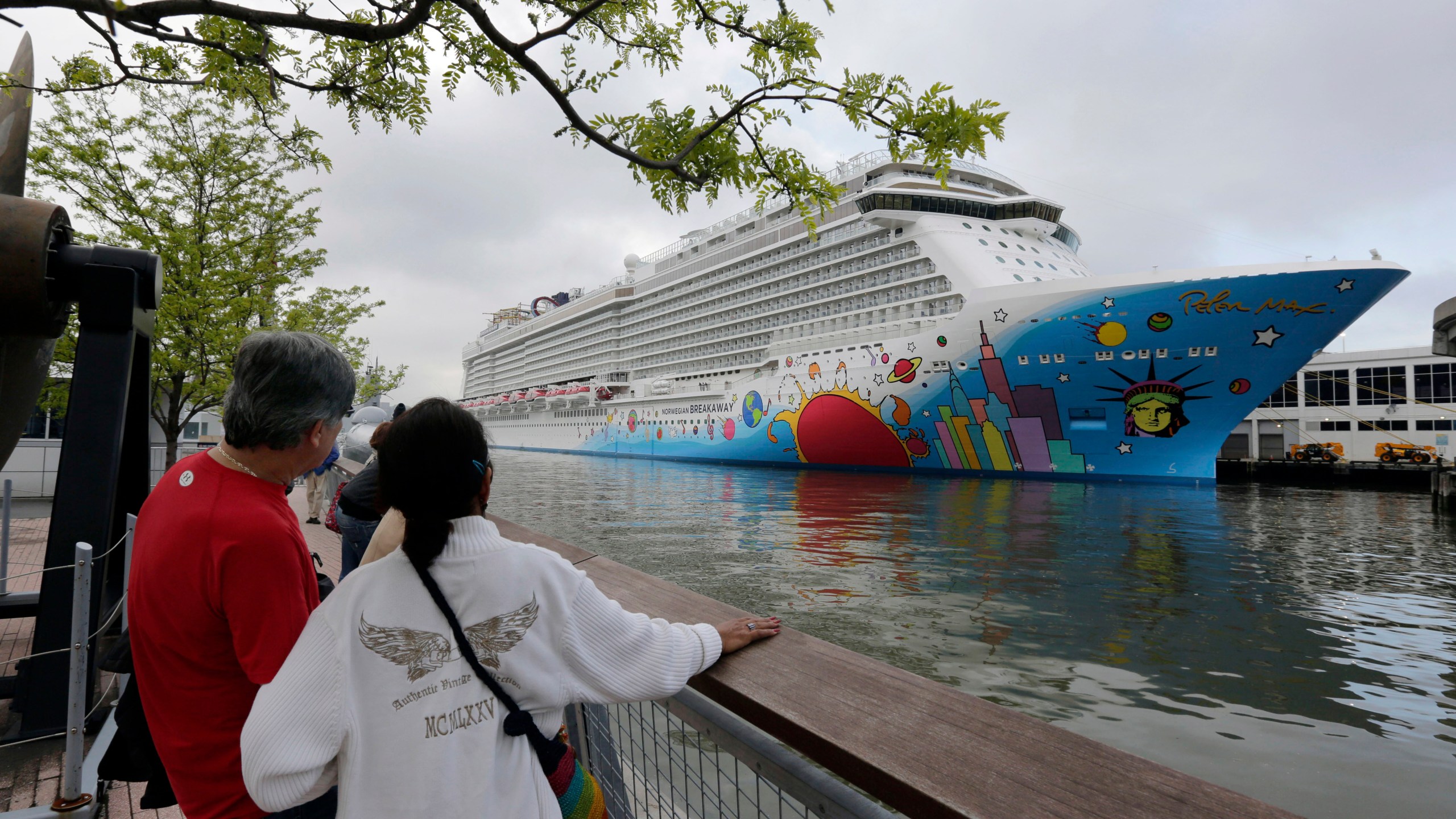 People pause to look at Norwegian Cruise Line's ship, Norwegian Breakaway, on the Hudson River, in New York, on May 8, 2013. Ten people aboard the cruise ship, approaching New Orleans, have tested positive for COVID-19, officials said Saturday night, Dec. 4, 2021. The Norwegian Breakaway had departed New Orleans on Nov. 28 and is due to return this weekend, the Louisiana Department of Health said in a news release. Over the past week, the ship made stops in Belize, Honduras and Mexico. (AP Photo/Richard Drew, File)