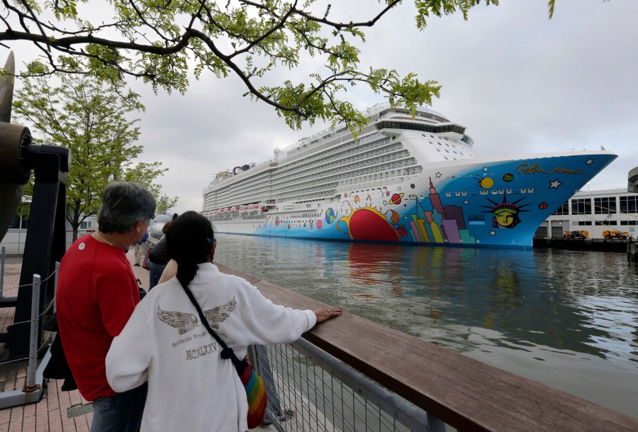 People pause to look at Norwegian Cruise Line's ship, Norwegian Breakaway, on the Hudson River, in New York, on May 8, 2013. Ten people aboard the cruise ship, approaching New Orleans, have tested positive for COVID-19, officials said Saturday night, Dec. 4, 2021. The Norwegian Breakaway had departed New Orleans on Nov. 28 and is due to return this weekend, the Louisiana Department of Health said in a news release. Over the past week, the ship made stops in Belize, Honduras and Mexico. (AP Photo/Richard Drew, File)