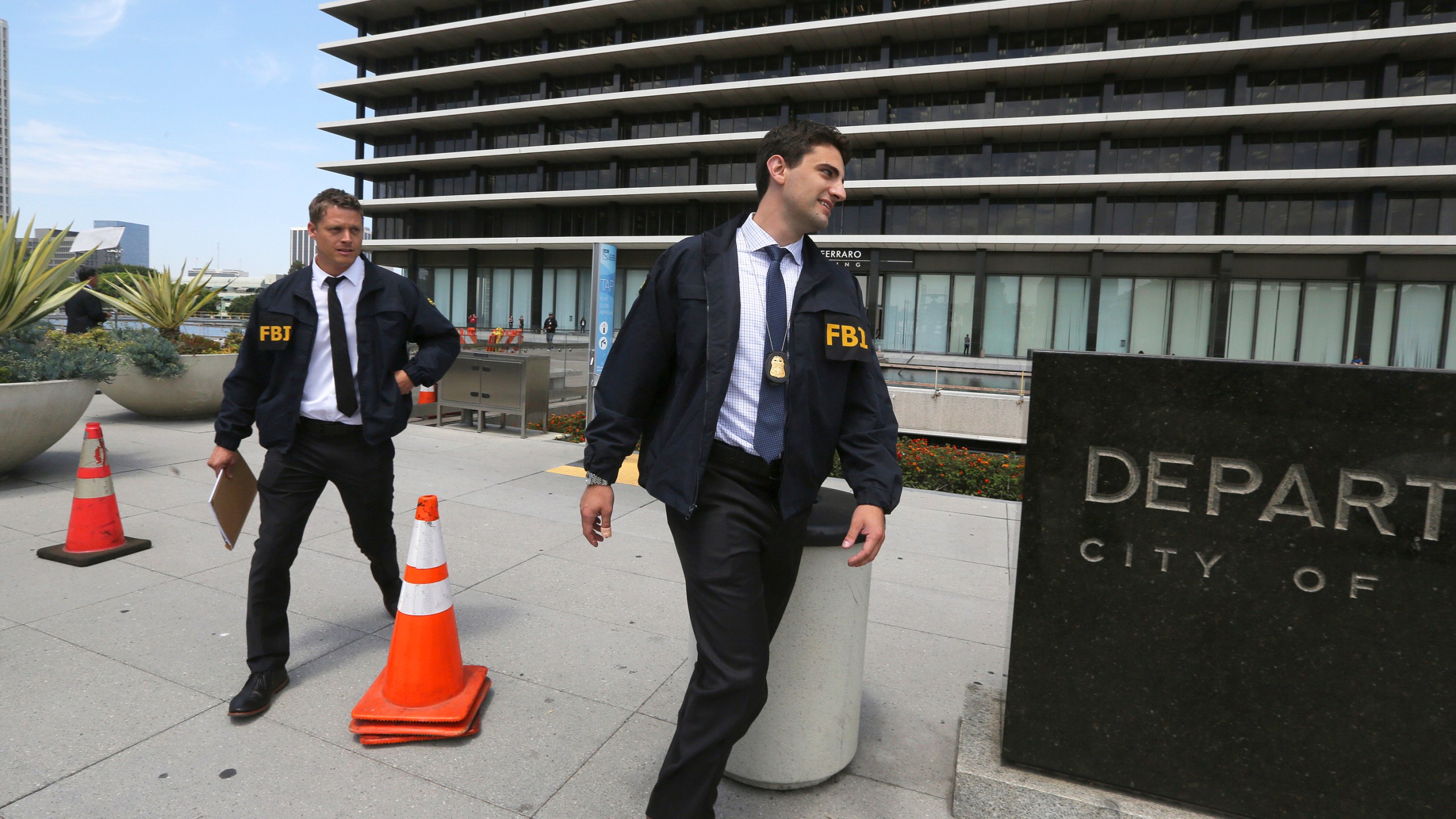 FBI agents leave the headquarters of the Los Angeles Department of Water and Power after spending several hours inside the building on July 22, 2019. David Wright, the former head of the Los Angeles Department of Water and Power, the nation's largest public utility, has agreed to plead guilty to taking bribes in a corruption scandal that grew out of an automated billing disaster that stuck ratepayers with exorbitant bills, federal prosecutors said Monday, Dec. 6, 2021. Los Angeles Mayor Eric Garcetti removed Wright from his job in 2019 after the FBI raided the water and power department and other city offices, months before his expected departure date. (AP Photo/Reed Saxon, File)