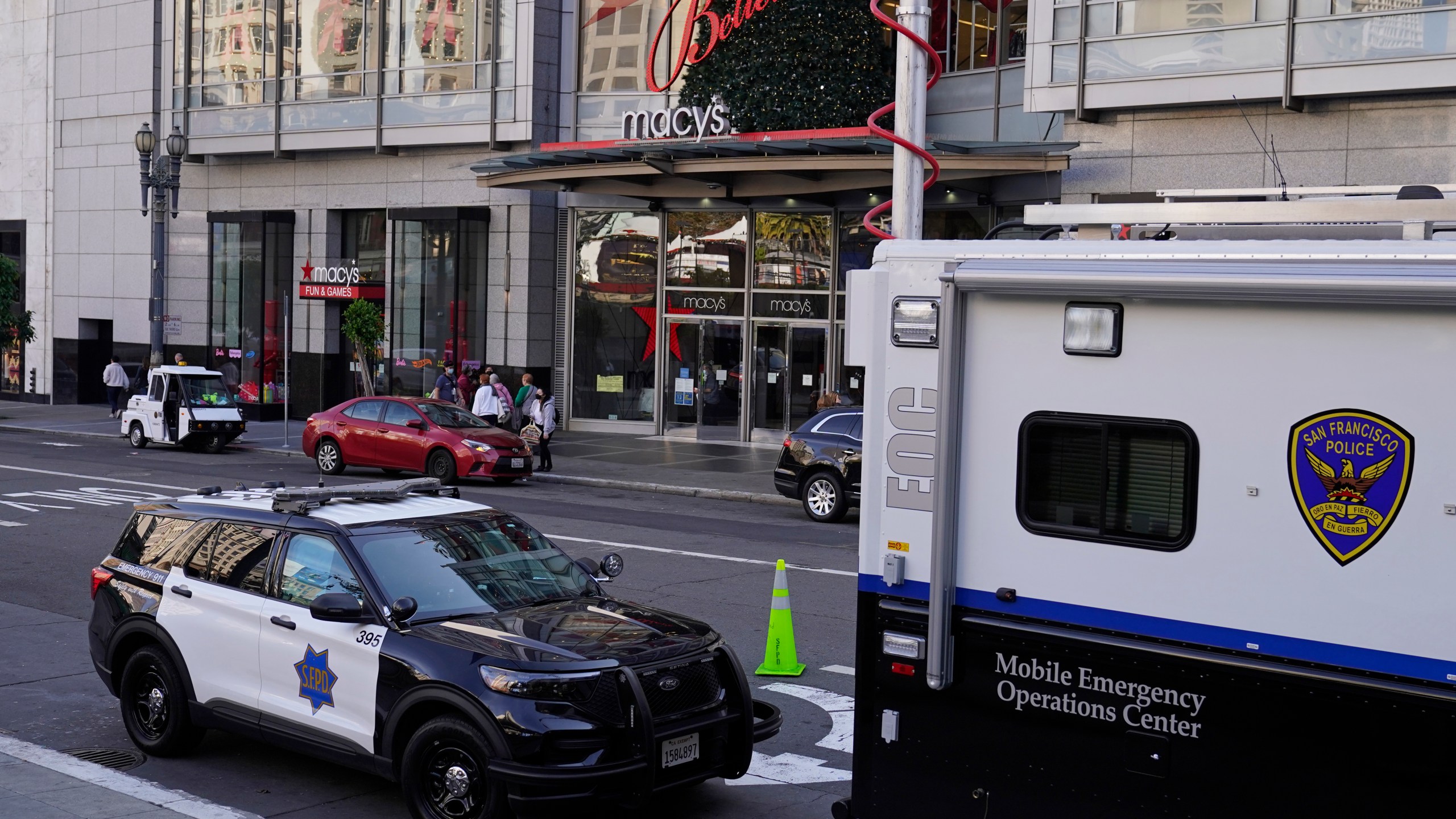 Police vehicles are stationed at Union Square following recent robberies in San Francisco, Thursday, Dec. 2, 2021. In San Francisco, homeless tents, open drug use, home break-ins and dirty streets have proliferated during the pandemic. The quality of life crimes and a laissez-faire approach by officials to brazen drug dealing have given residents a sense the city is in decline.(AP Photo/Eric Risberg)