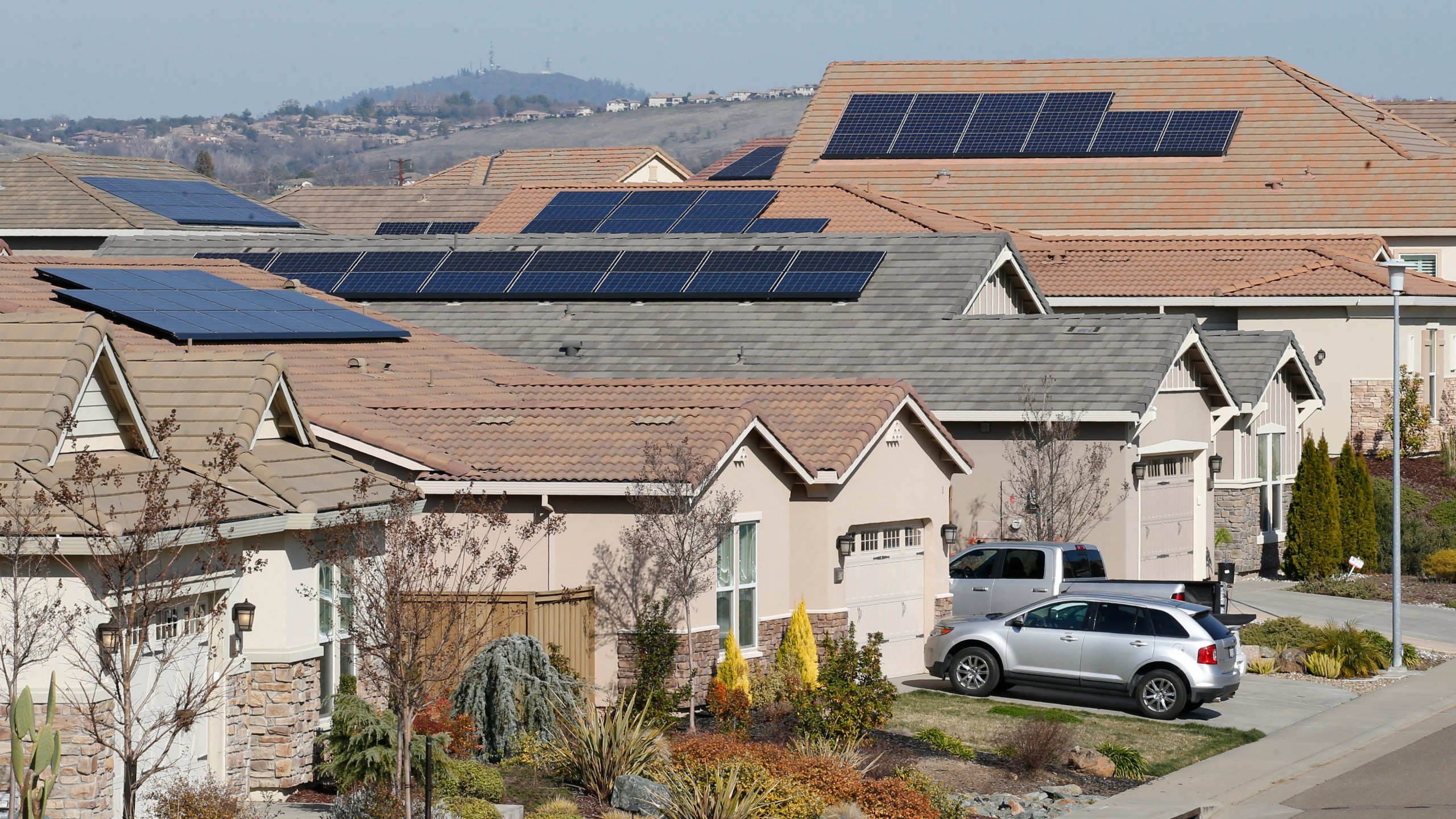 This photo taken Feb. 12, 2020, shows solar panels on rooftops of a housing development in Folsom, Calif. (AP Photo/Rich Pedroncelli, File)