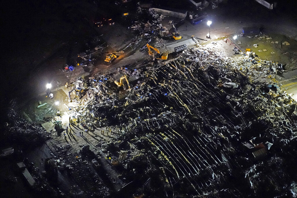 In this aerial file photo, a collapsed factory is seen with workers searching for survivors, after tornadoes came through the area the previous night, in Mayfield, Ky., Saturday, Dec. 11, 2021. (AP Photo/Gerald Herbert, File)