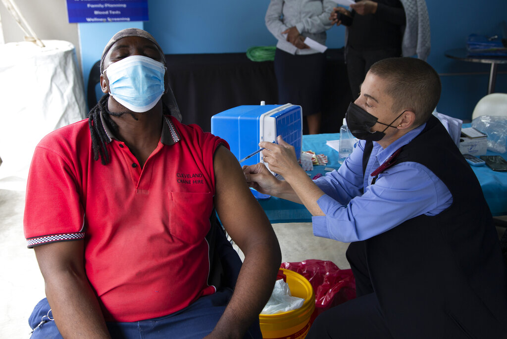 A man gets vaccinated against COVID-19 on Monday, Dec. 13, 2021. (AP Photo/Denis Farrell)