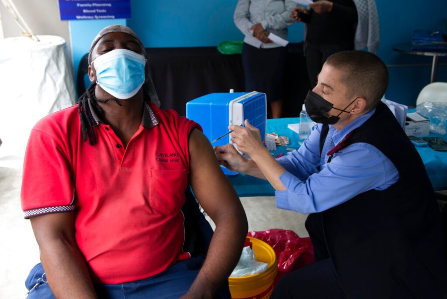 A man gets vaccinated against COVID-19 on Monday, Dec. 13, 2021. (AP Photo/Denis Farrell)