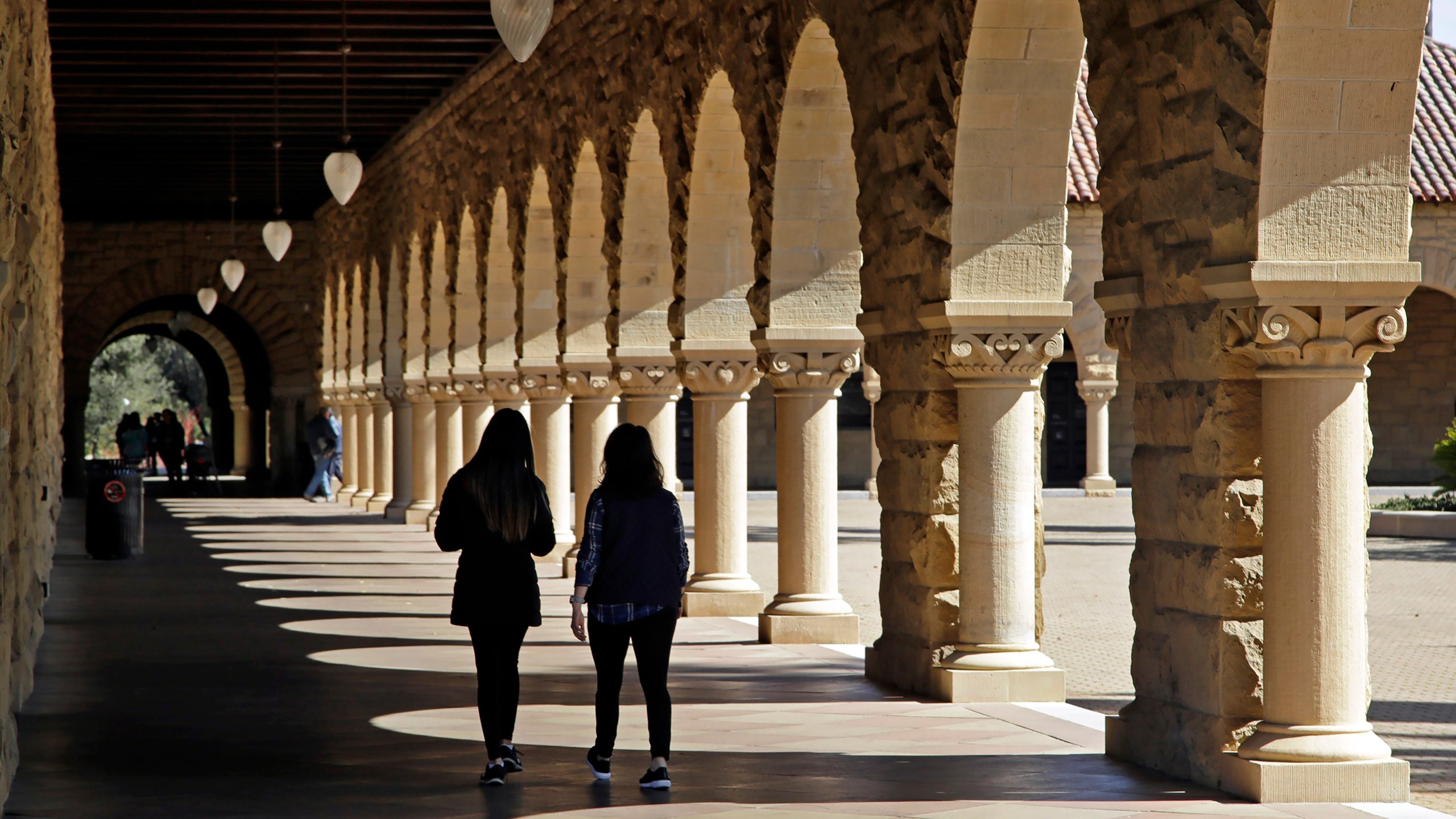 Students walk on the Stanford University campus in Stanford, Calif, March 14, 2019. (AP Photo/Ben Margot, File)