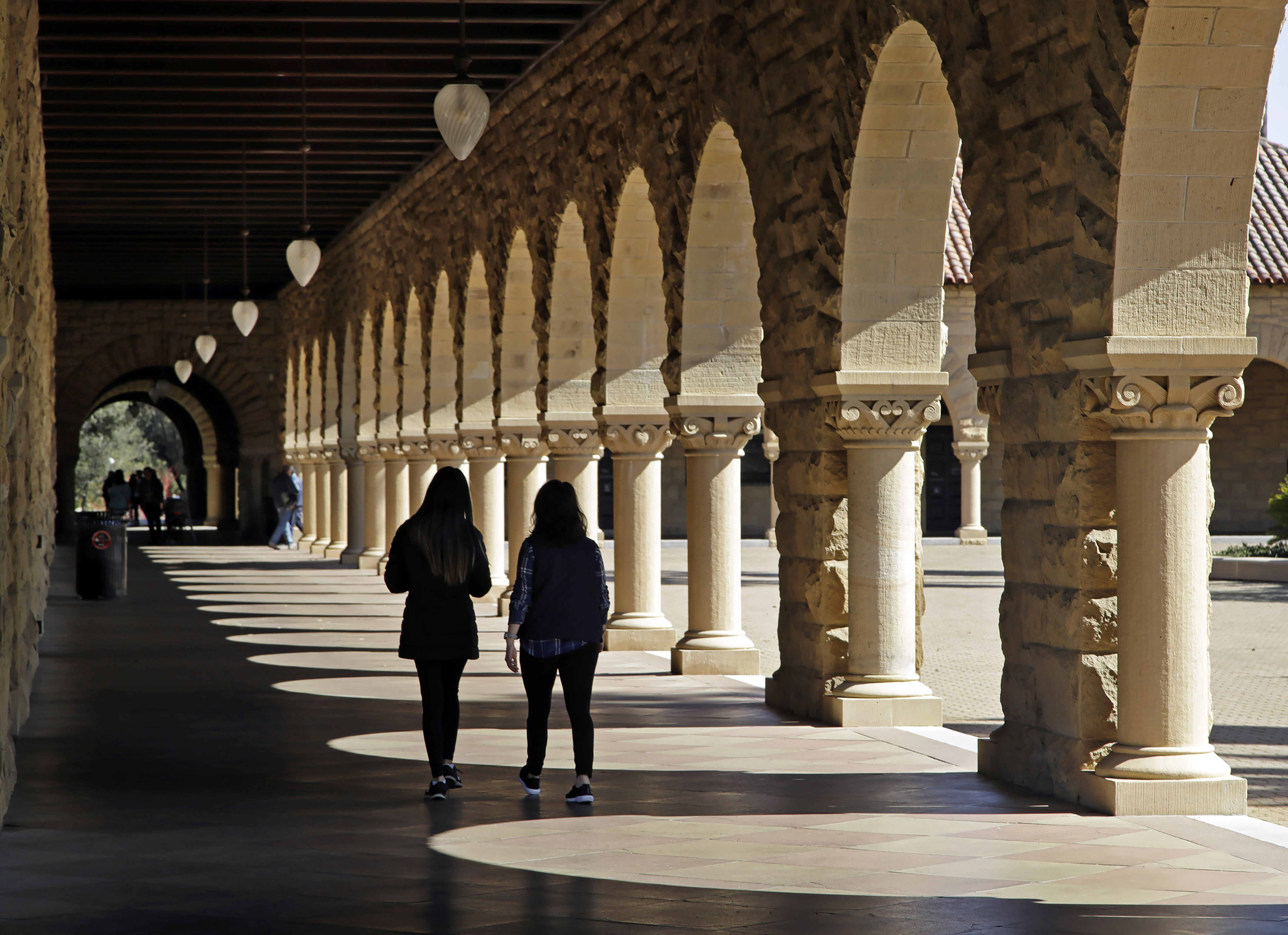 Students walk on the Stanford University campus in Stanford, Calif, March 14, 2019. (AP Photo/Ben Margot, File)