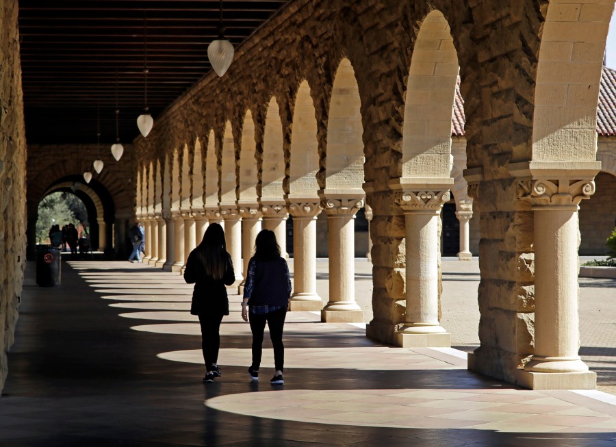 Students walk on the Stanford University campus in Stanford, Calif, March 14, 2019. (AP Photo/Ben Margot, File)