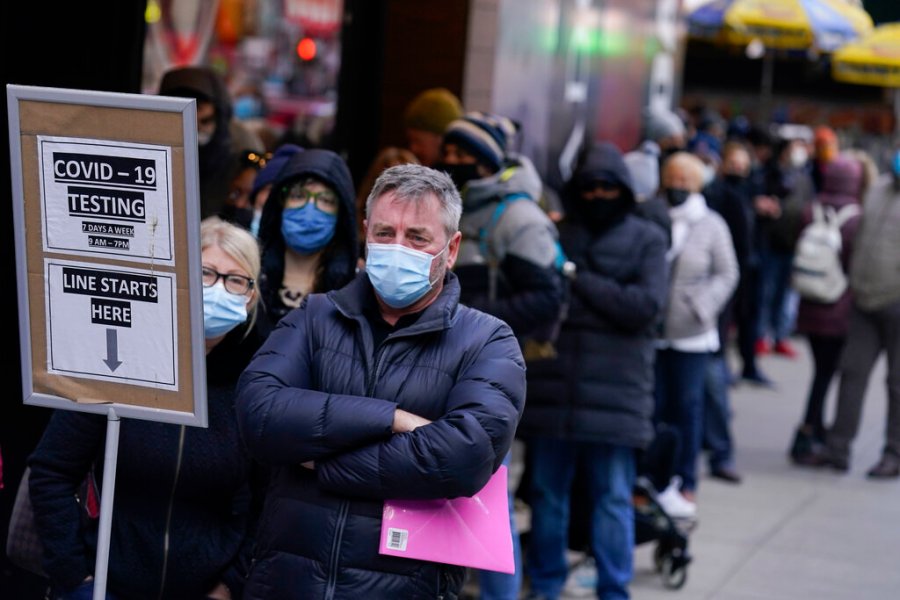 People wait in line at a COVID-19 testing site in Times Square, New York, Monday, Dec. 13, 2021. (AP Photo/Seth Wenig, File)