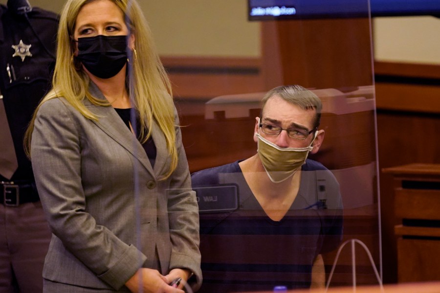 James Crumbley looks past his attorney to his wife during a probable cause hearing in Rochester Hills, Mich., Dec. 14, 2021. (Carlos Osorio/Associated Press)