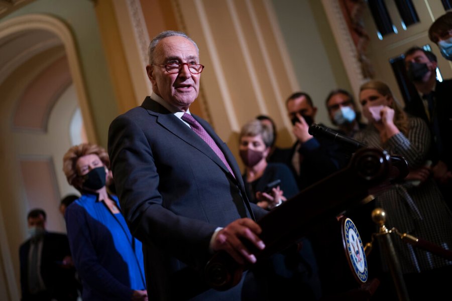 Senate Majority Leader Chuck Schumer, D-N.Y., speaks to reporters after a Democratic policy meeting at the Capitol in Washington, Tuesday, Dec. 14, 2021. (AP Photo/J. Scott Applewhite)