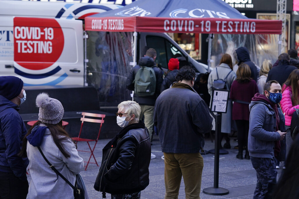 People wait in line at a COVID-19 testing site in Times Square, New York, Dec. 13, 2021. (AP Photo/Seth Wenig, File)