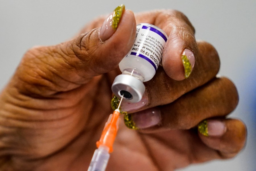 A syringe is prepared with the Pfizer COVID-19 vaccine at a vaccination clinic at the Keystone First Wellness Center in Chester, Pa., on Dec. 15, 2021. (Matt Rourke/Associated Press)