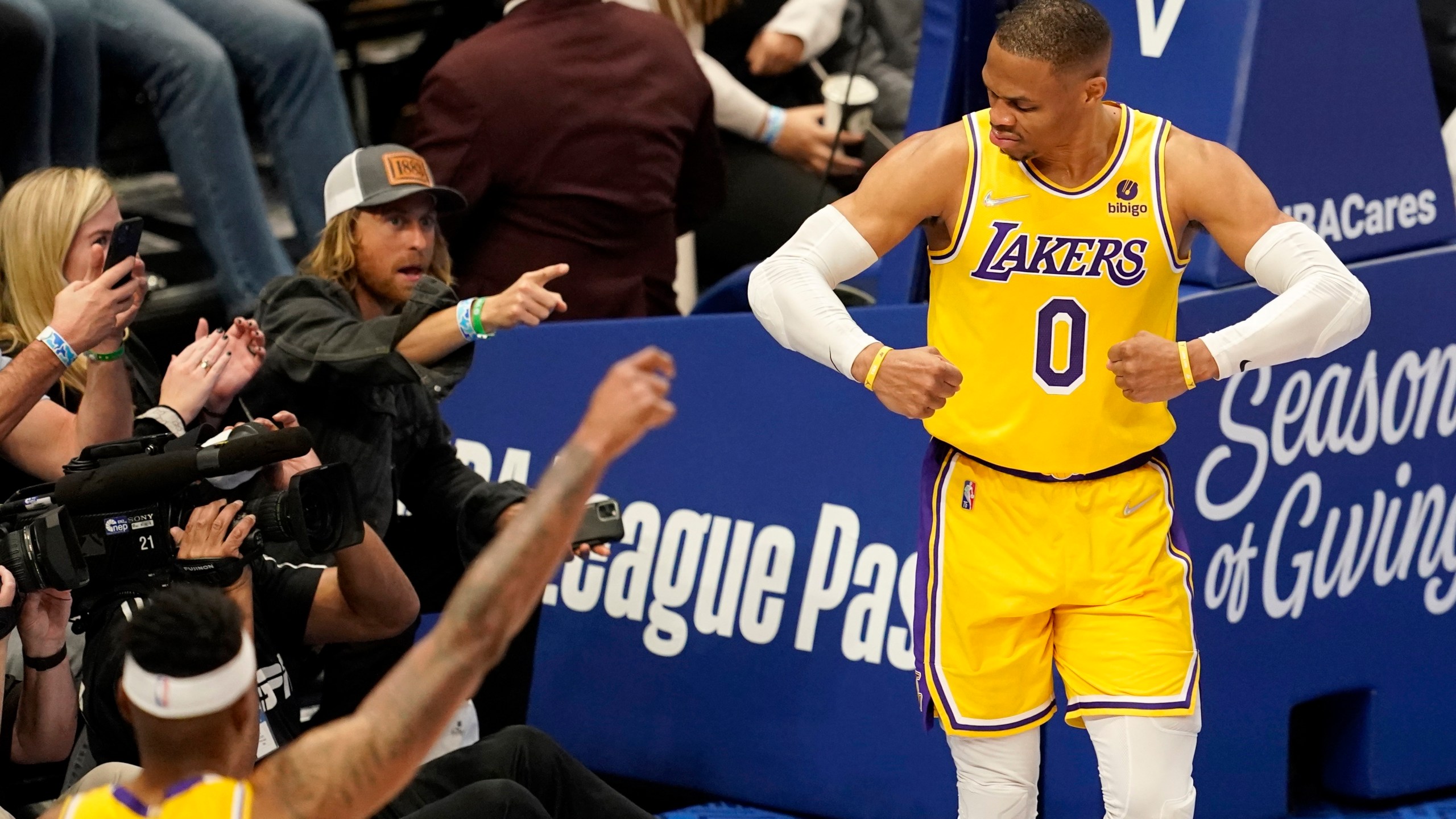 Los Angeles Lakers' Russell Westbrook (0) celebrates after sinking a basket as fans look on in the second half of an NBA basketball game in Dallas on Dec. 15, 2021. (AP Photo/Tony Gutierrez)