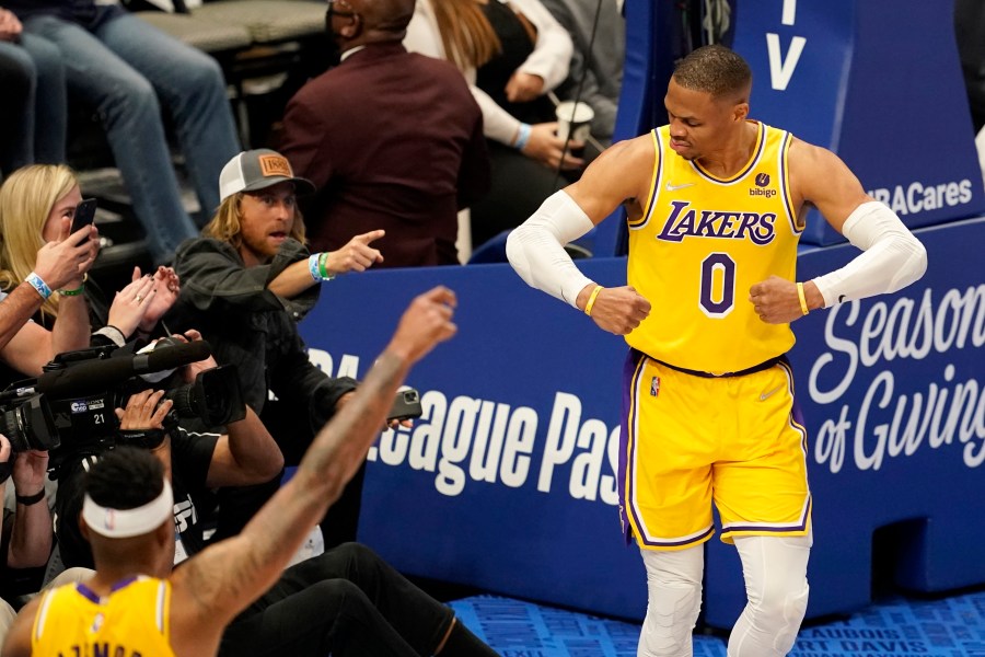 Los Angeles Lakers' Russell Westbrook (0) celebrates after sinking a basket as fans look on in the second half of an NBA basketball game in Dallas on Dec. 15, 2021. (AP Photo/Tony Gutierrez)