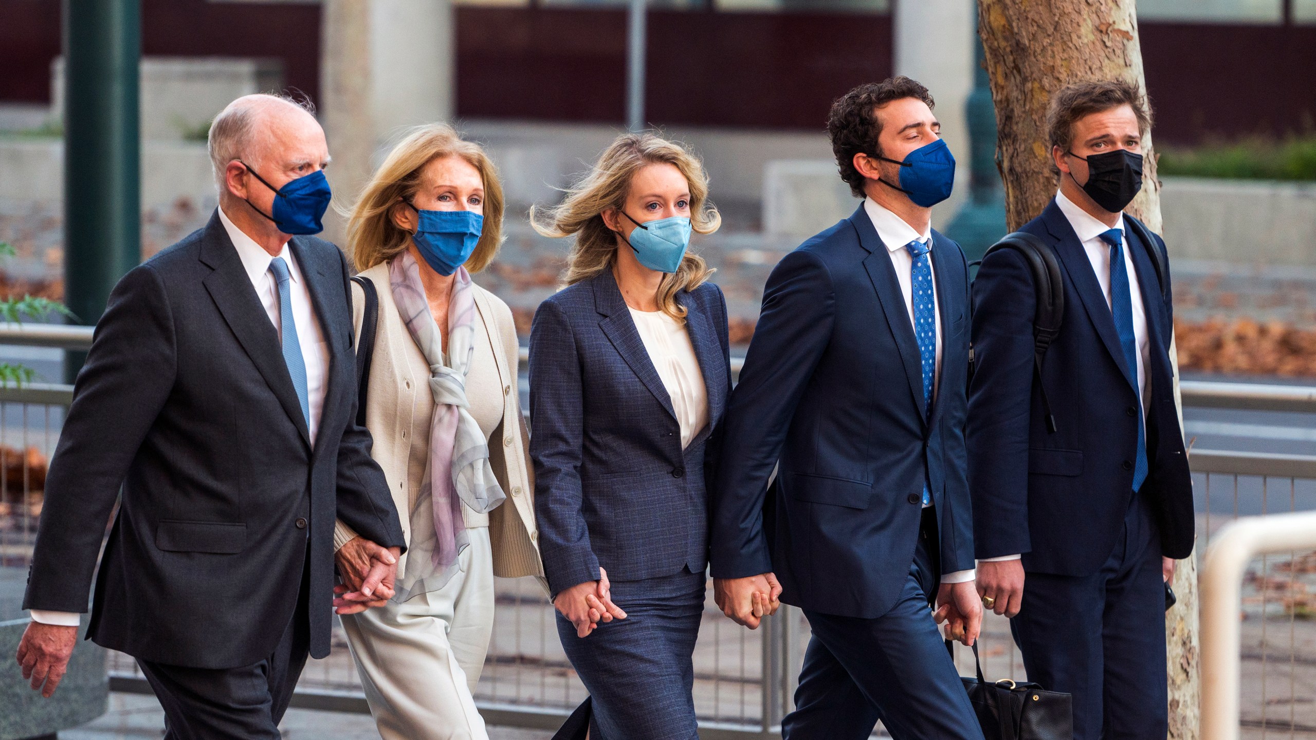 Elizabeth Holmes, center, walks into federal court in San Jose, Calif., Friday, Dec. 17, 2021. The lawyers for the opposing sides in the trial of former Theranos CEO are expected to wrap up their closing arguments Friday, paving the way for a jury to begin their deliberations over criminal charges accusing her of turning her blood-testing startup into a massive scam. (AP Photo/Nic Coury)