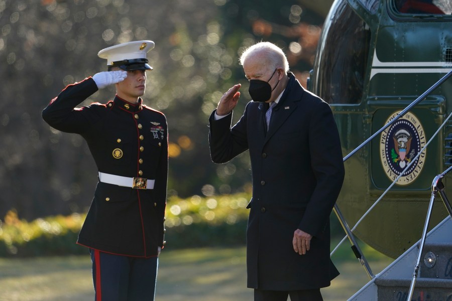 President Joe Biden salutes as he steps off Marine One on the South Lawn of the White House in Washington, Monday, Dec. 20, 2021. Biden is returning to Washington after spending the weekend at his home in Delaware. (AP Photo/Patrick Semansky)