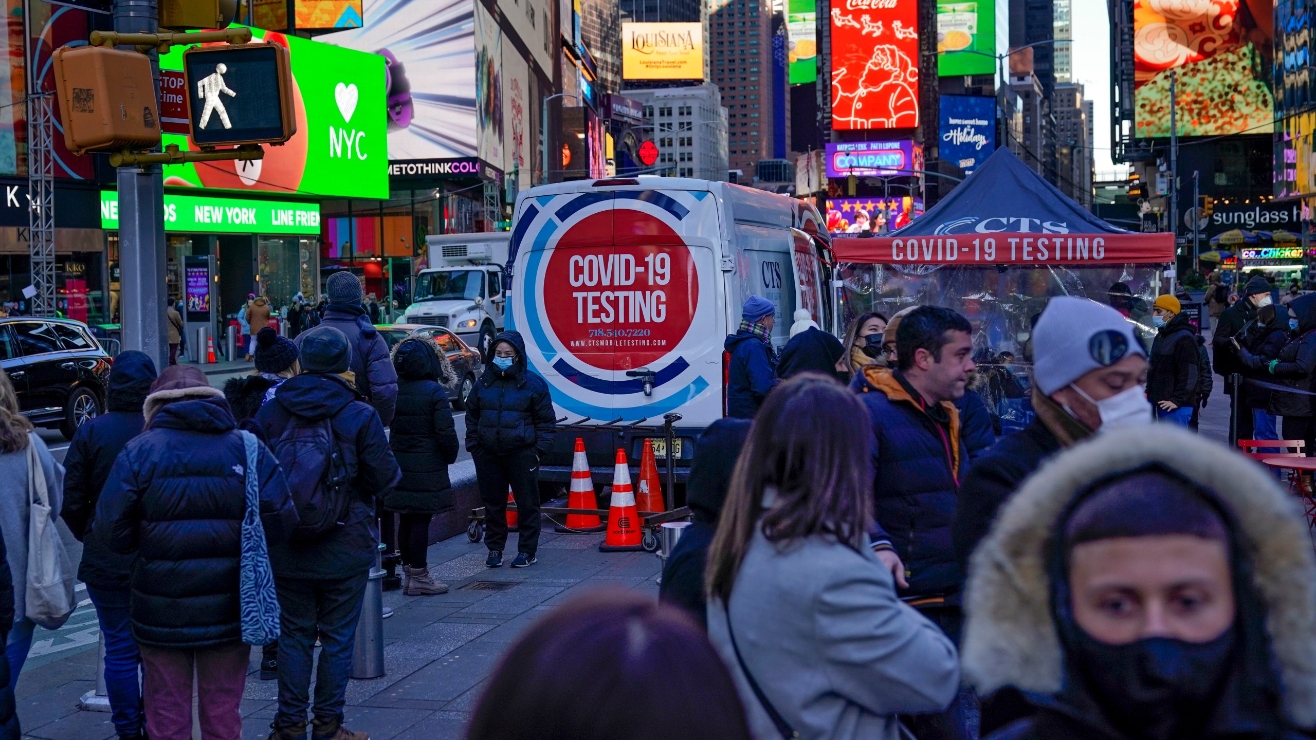 People wait in a long line to get tested for COVID-19 in Times Square in New York on Dec. 20, 2021. (AP Photo/Seth Wenig)