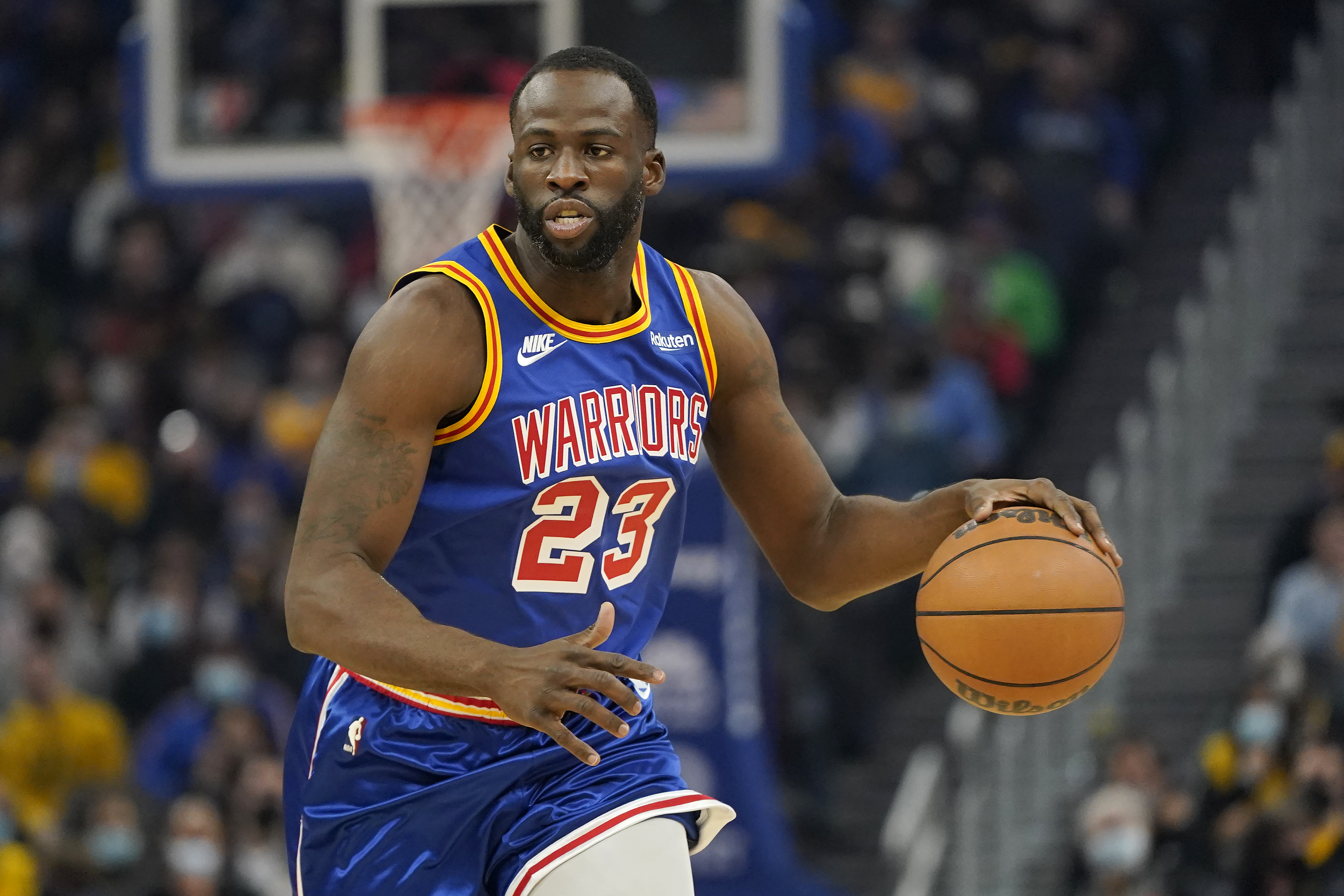 Golden State Warriors forward Draymond Green (23) dribbles the ball up the court against the Memphis Grizzlies during the first half of an NBA basketball game in San Francisco, Thursday, Dec. 23, 2021. (AP Photo/Jeff Chiu)