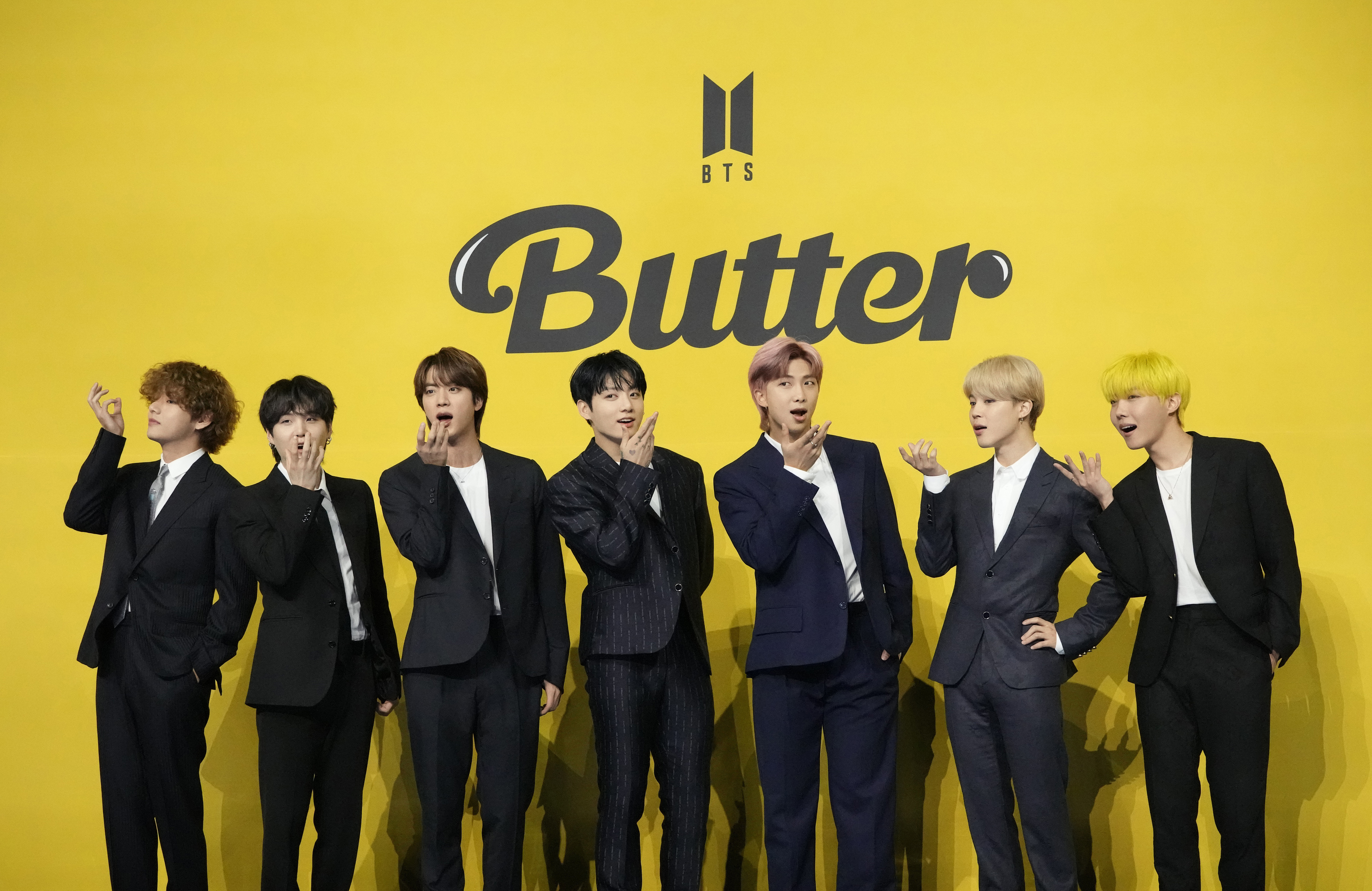 Members of South Korean K-pop band BTS, V, SUGA, JIN, Jung Kook, RM, Jimin, and j-hope from left to right, pose for photographers ahead of a press conference to introduce their new single "Butter" in Seoul, South Korea, Friday, May 21, 2021. Three members of the K-pop superstar group BTS have been infected with the coronavirus.  the Big Hit Entertainment agency says in a statement that RM and Jin were diagnosed with COVID-19 on Saturday evening. It earlier said another member, Suga, tested positive for the virus on Friday. (AP Photo/Lee Jin-man, File)