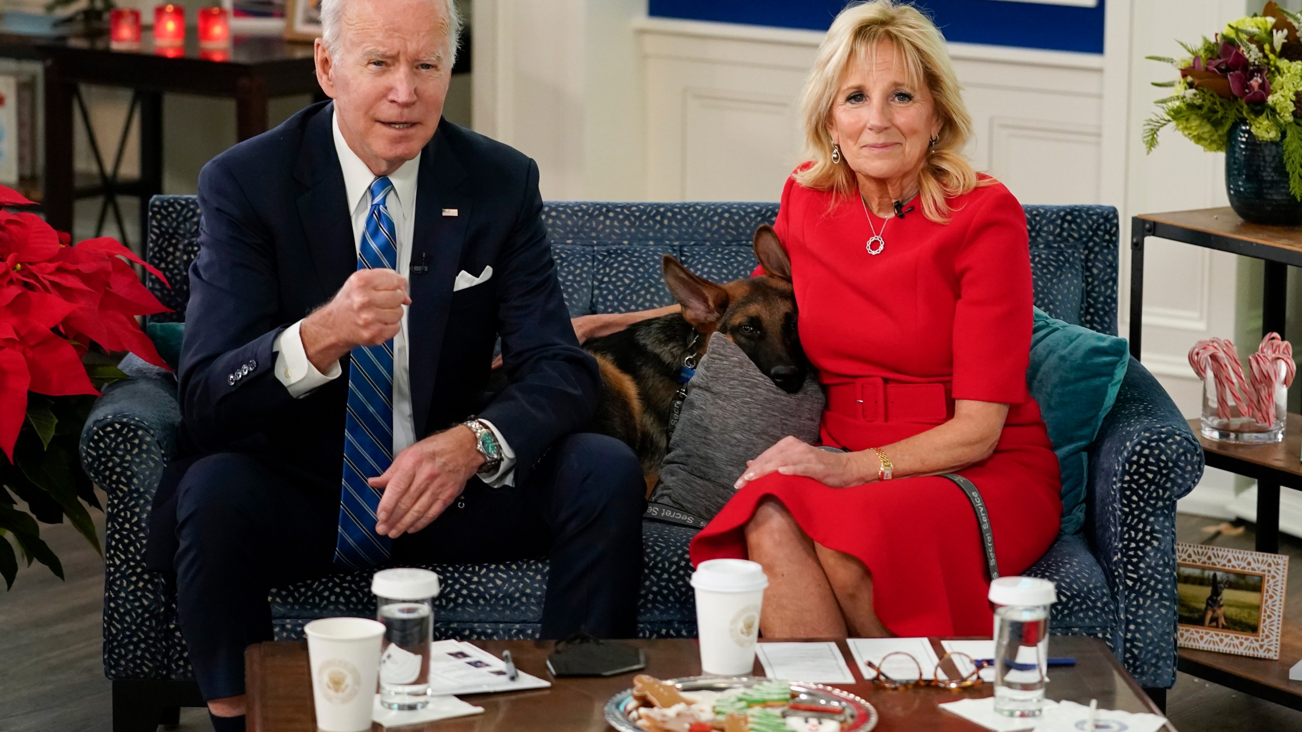 President Joe Biden, first lady Jill Biden and their new dog Commander, a purebred German shepherd puppy, meet virtually with service members around the world, Saturday, Dec. 25, 2021, in the South Court Auditorium on the White House campus in Washington, to thank them for their service and wish them a Merry Christmas. (AP Photo/Carolyn Kaster)