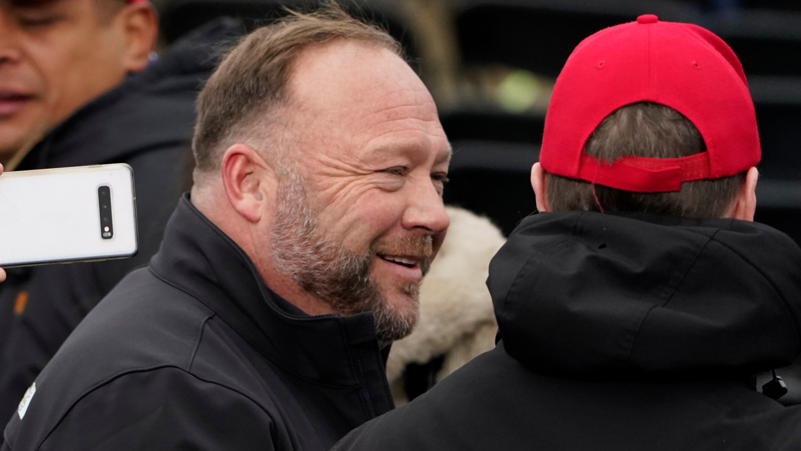 Alex Jones, left, attends a rally in support of President Donald Trump called the "Save America Rally," Wednesday, Jan. 6, 2021, in Washington. The wife of the conspiracy theorist was arrested Friday, Dec. 24, 2021, Christmas Eve on a domestic violence charge that the right-wing provocateur said stems from a “medication imbalance.” (AP Photo/Jacquelyn Martin, File)