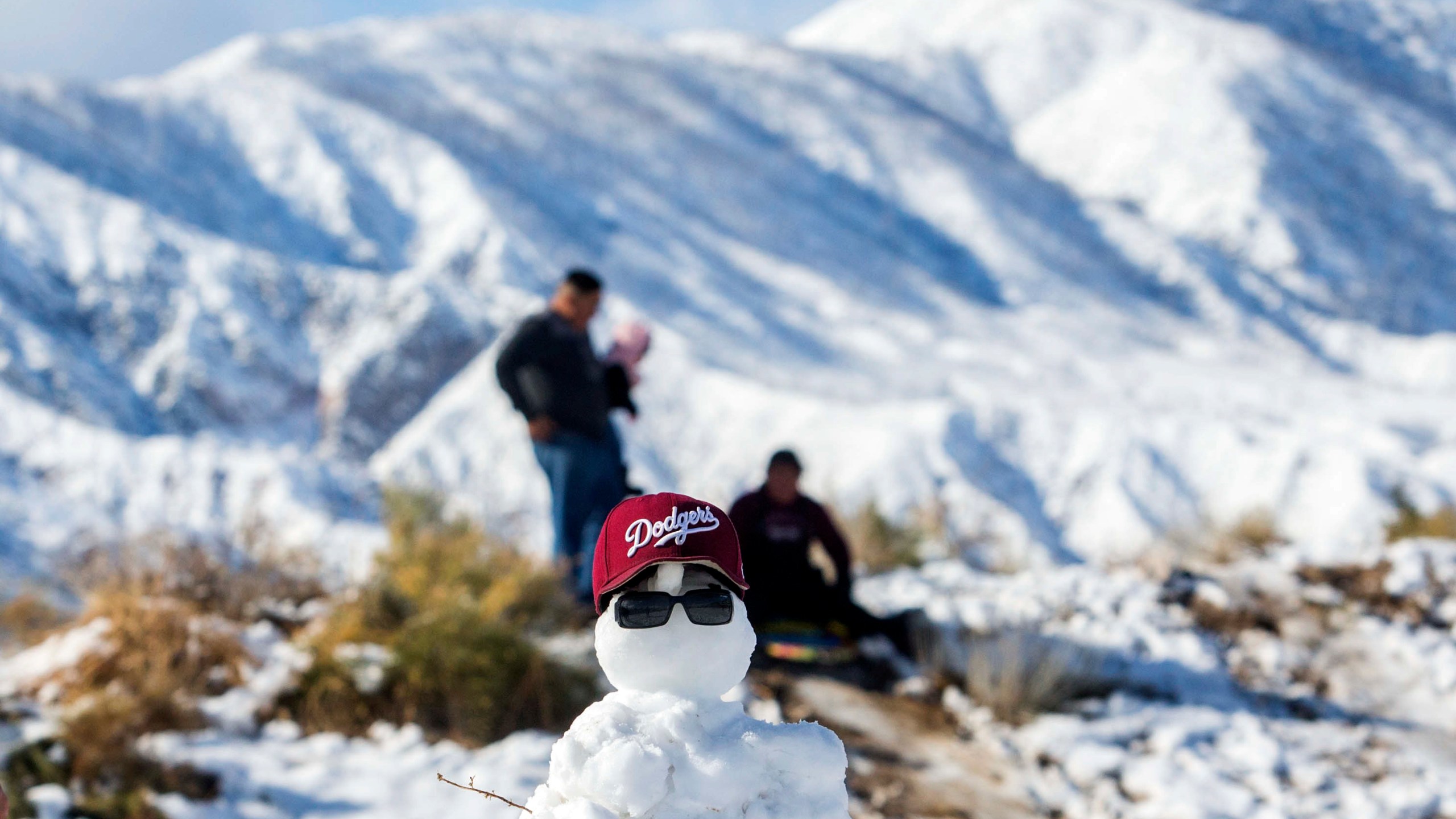 People play on the snow next to the 138 Highway around San Bernardino Forest on Nov. 29, 2019 in Phelan, California. (APU GOMES/AFP via Getty Images)