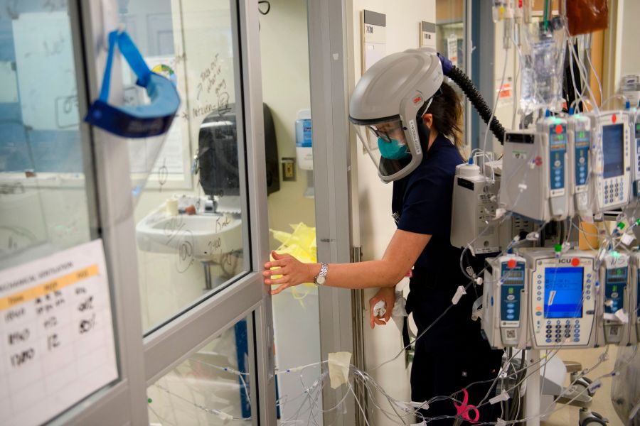 This file photo shows a nurse closing a door to a patient's room in a COVID-19 intensive care unit at Martin Luther King Jr. Community Hospital on Jan. 6, 2021 in the Willowbrook neighborhood of Los Angeles. (PATRICK T. FALLON/AFP via Getty Images)