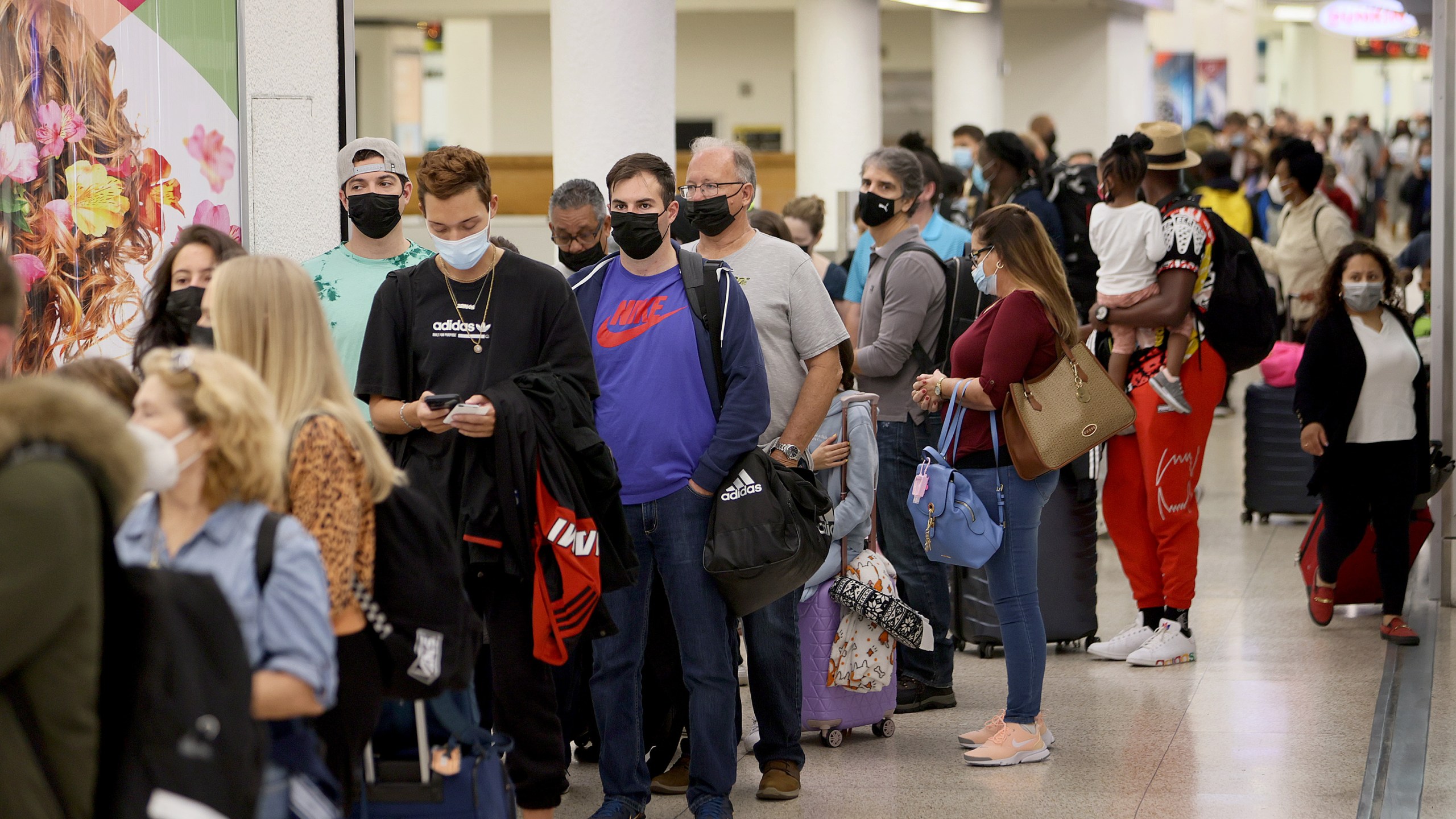 People wait in the line to clear through the TSA checkpoint at Miami International Airport on Nov. 24, 2021, in Miami, Florida. (Joe Raedle/Getty Images)