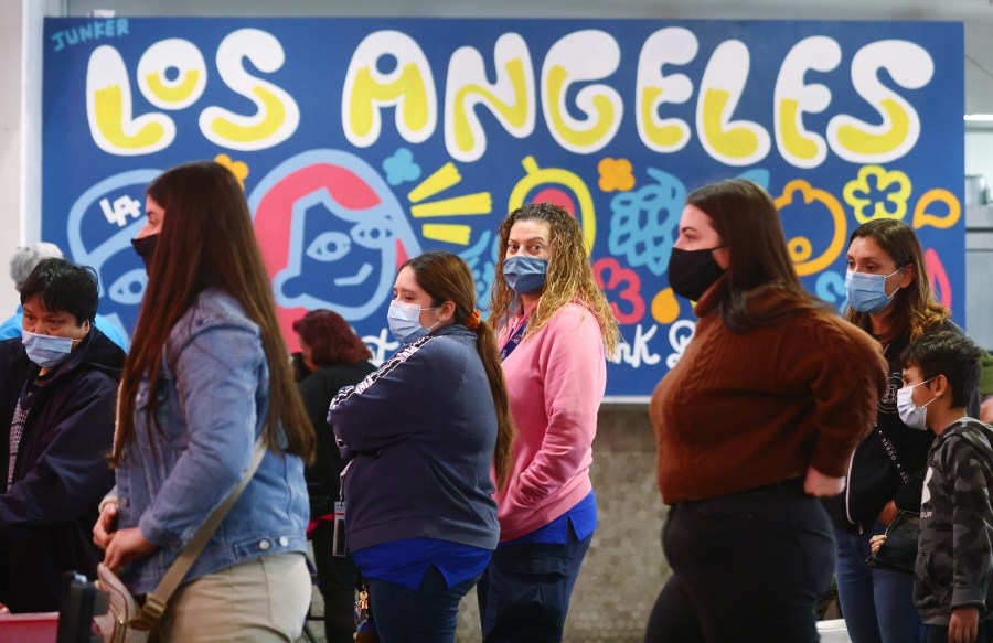 People wear face coverings inside Grand Central Market on Dec. 15, 2021 in Los Angeles, California. (Mario Tama/Getty Images)