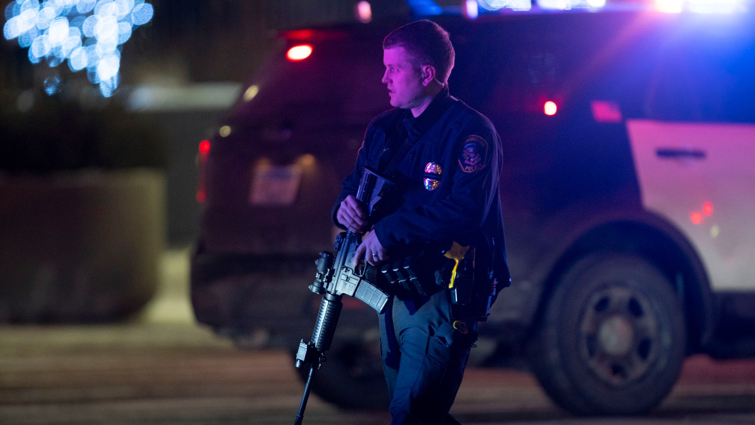 A police officer carrying a rifle exits the Mall of America following a shooting, Friday, Dec. 31, 2021, in Minnesota. Two people were shot and wounded following an apparent altercation at the Mall of America Friday, sending New Year's Eve shoppers scrambling for safety and placing the Minneapolis mall on temporary lockdown, authorities said. (Alex Kormann/Star Tribune via AP)