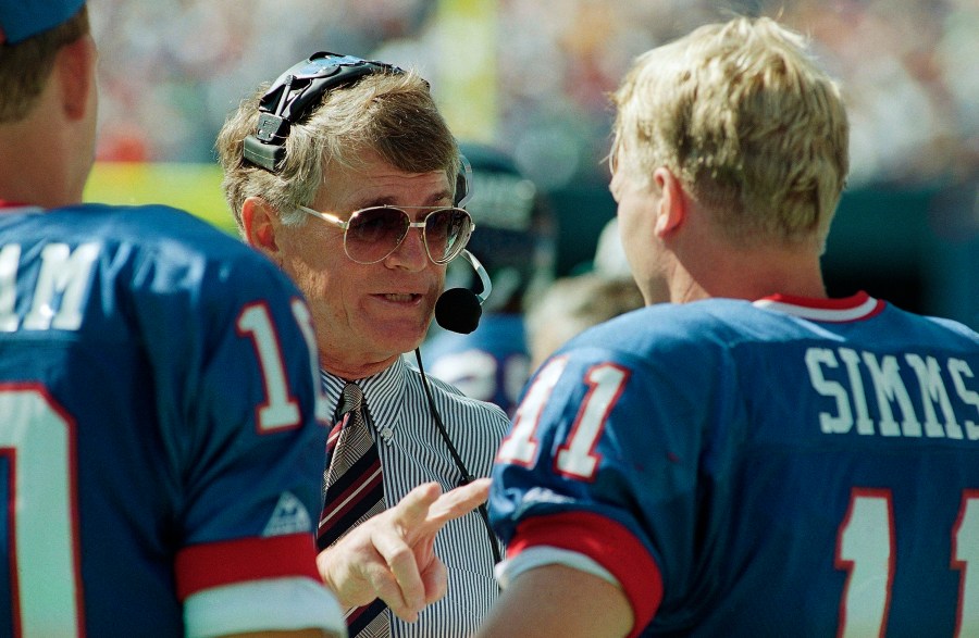 New York Giants head coach Dan Reeves gives some instructions to his starting quarterback Phil Simms during the third quarter of their game against the Tampa Bay Buccaneers at Giants Stadium in East Rutherford, N.J. on Sept. 12, 1993. (Mark Lennihan/Associated Press)