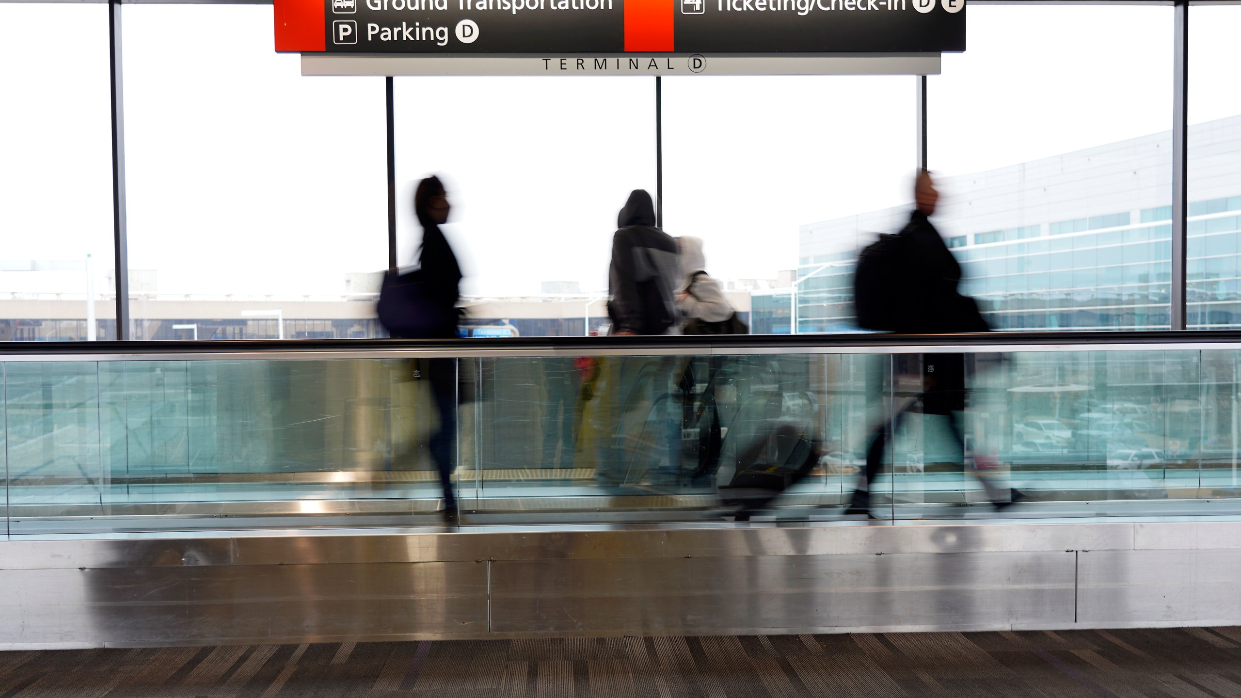 Travelers walk to their gates at the Philadelphia International Airport on Friday, Dec. 31, 2021, in Philadelphia. (Michael Perez/Associated Press)