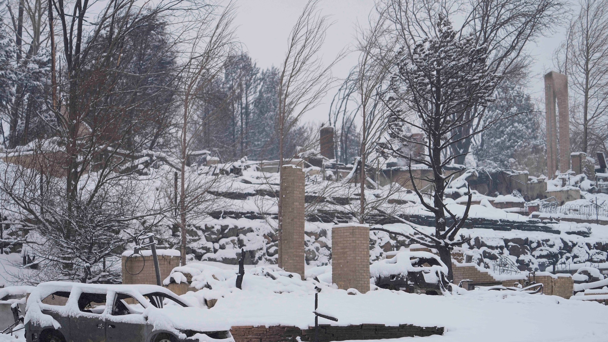 Snow covers the burned remains of homes in Louisville, Colo., on Jan. 1, 2022, after the Marshall Wildfire. (Jack Dempsey/Associated Press)