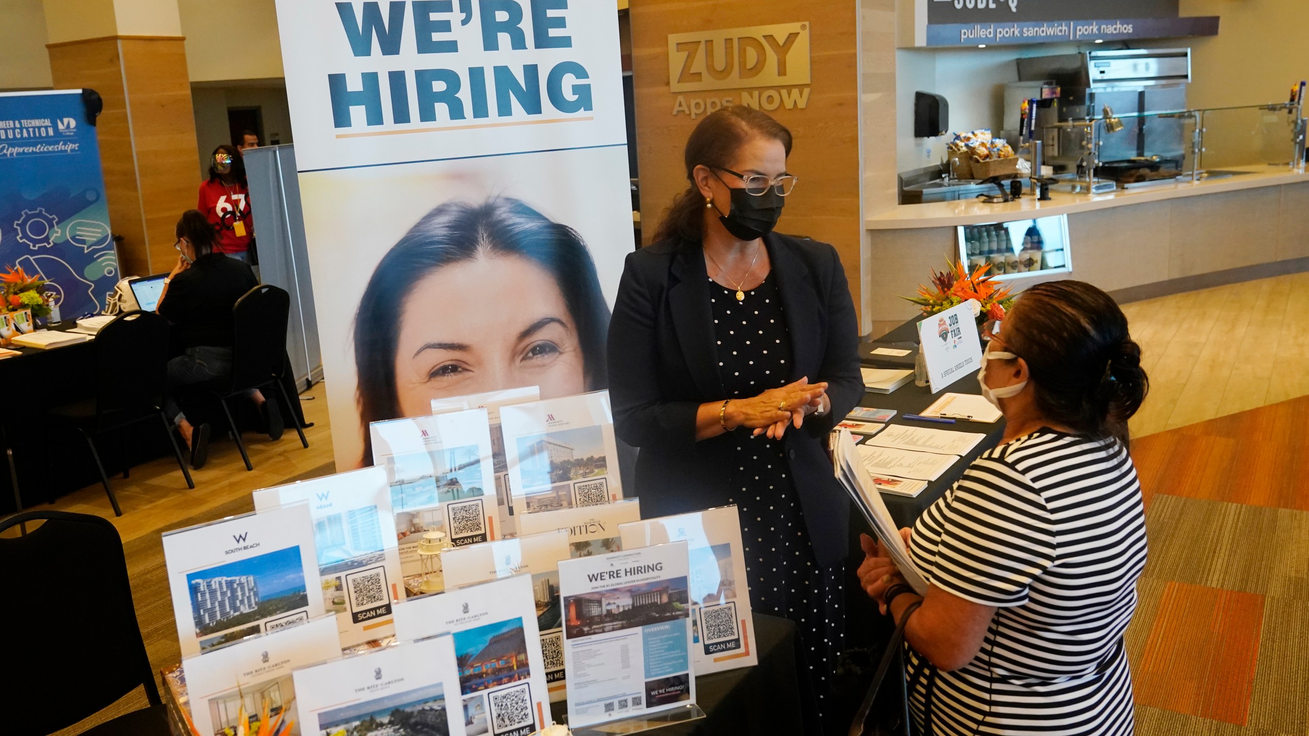 Marriott human resources recruiter Mariela Cuevas, left, talks to Lisbet Oliveros, during a job fair at Hard Rock Stadium on Sept. 3, 2021, in Miami Gardens, Fla. (AP Photo/Marta Lavandier, File)