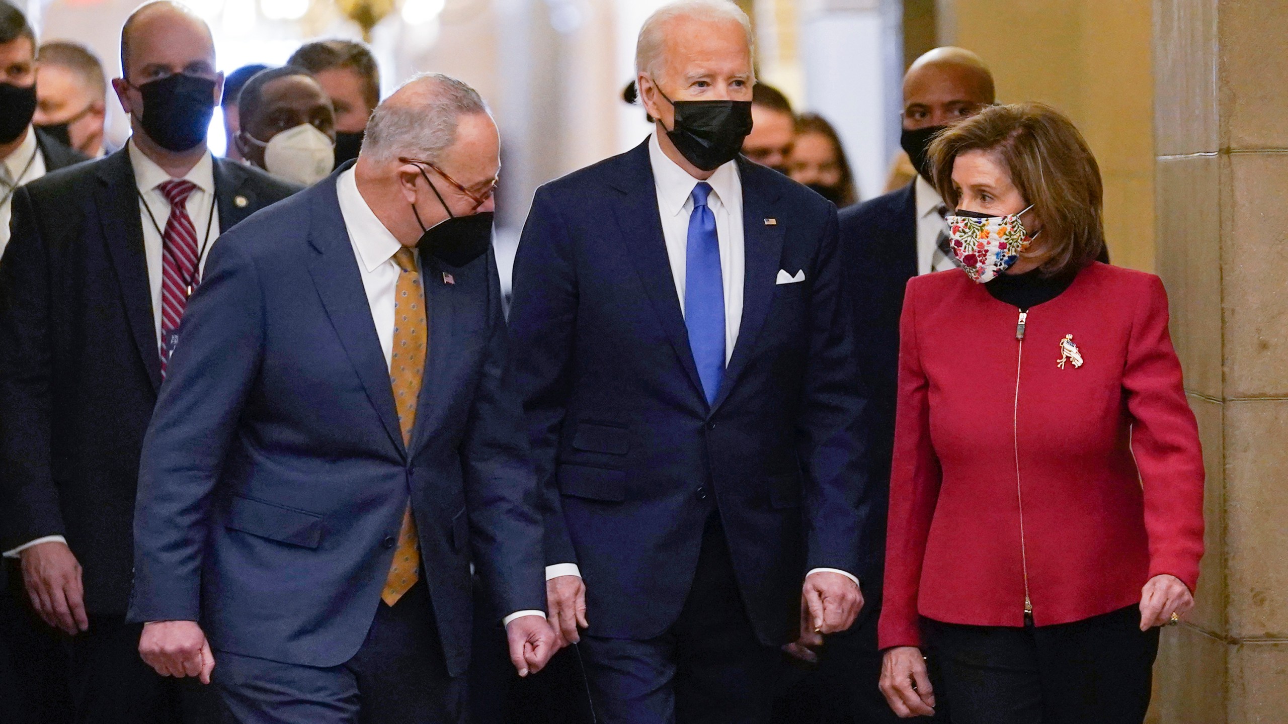 President Joe Biden is flanked by Senate Majority Leader Chuck Schumer of N.Y., left, and House Speaker Nancy Pelosi of Calif., right, after arriving on Capitol Hill in Washington, on Thursday, Jan. 6, 2022. (AP Photo/Susan Walsh)