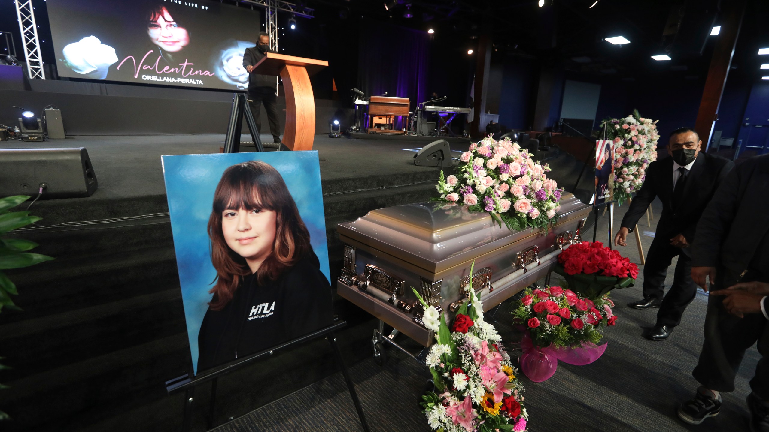 The casket containing 14-year-old Valentina Orellana Peralta, killed on Dec. 23, 2021, by a LAPD officer's stray bullet while shopping with her mother, is readied for her funeral at the City of Refuge Church in Gardena, Calif. on Jan. 10, 2022. (AP Photo/David Swanson)