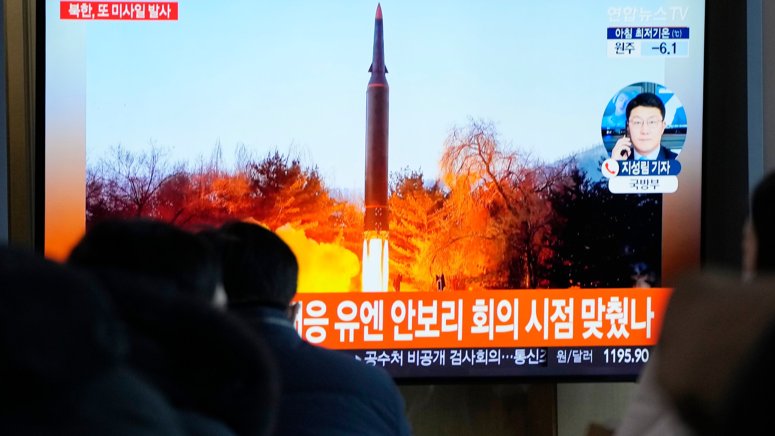 People watch a TV showing a file image of North Korea's missile launch during a news program at the Seoul Railway Station in Seoul, South Korea, Tuesday, Jan. 11, 2022. North Korea on Tuesday fired what appeared to be a ballistic missile into its eastern sea, its second weapons launch in a week, the militaries of South Korea and Japan said. The Korean letters read "UN Security Council meeting." (AP Photo/Ahn Young-joon)