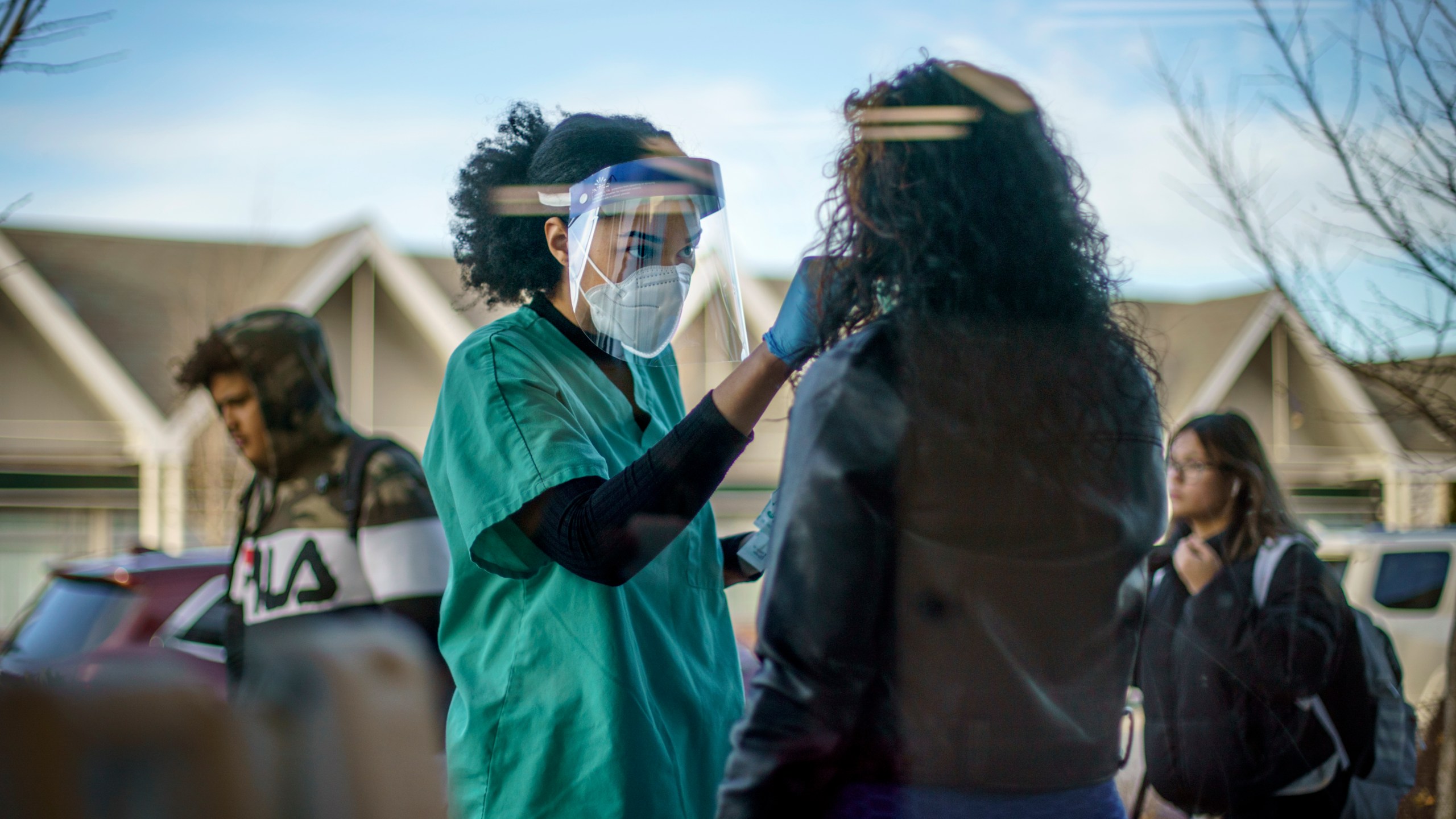 Maya Goode, a COVID-19 technician, performs a test on Jessica Sanchez outside Asthenis Pharmacy in Providence, R.I. on Dec. 7, 2021. (AP Photo/David Goldman, File)