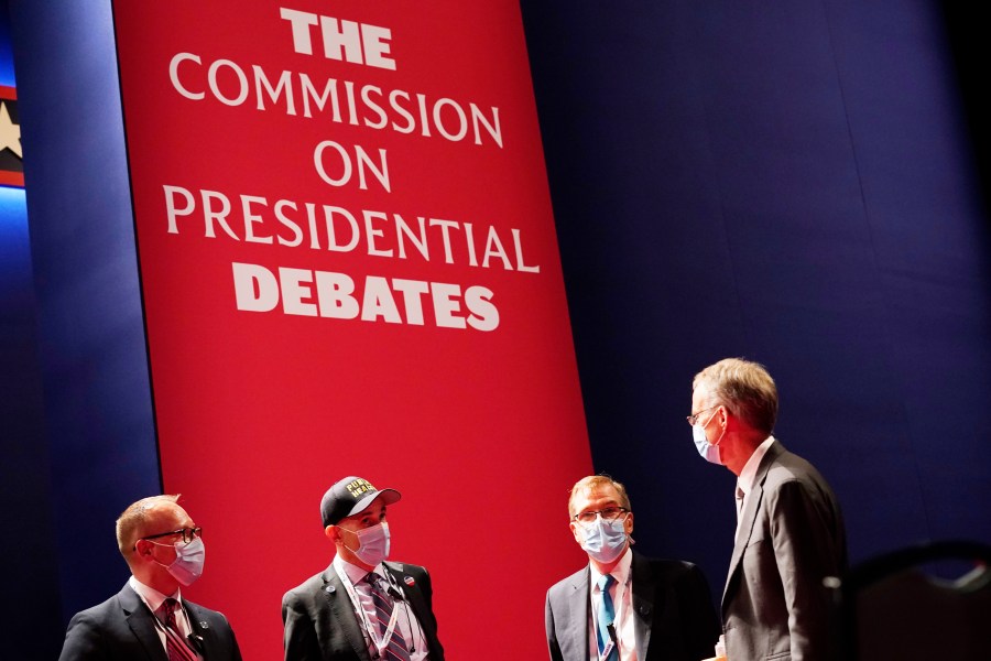 Officials from the Commission on Presidential Debates gather near the stage before the start of the second and final presidential debate, Oct. 22, 2020, at Belmont University in Nashville, Tenn. The Republican National Committee says it is planning a rules change that would force presidential candidates seeking the party’s nomination to sign a pledge saying they will not participate in any debates sponsored by the Commission on Presidential Debates. (AP Photo/Patrick Semansky, File)