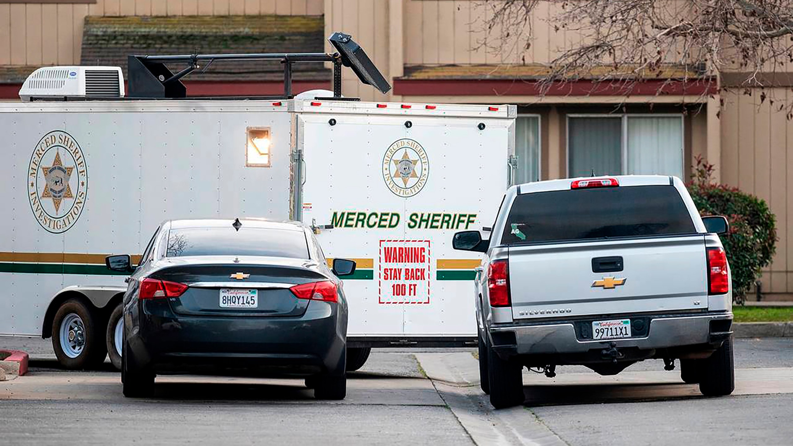 The Merced County Sheriff's Office investigate after three children were found dead inside a residence at an apartment complex in Le Grand, Calif., on Wednesday, Jan. 12, 2022. The mother of three children found dead inside a central California home has been charged with murder, officials said Thursday. (Andrew Kuhn/The Merced Sun-Star via AP)