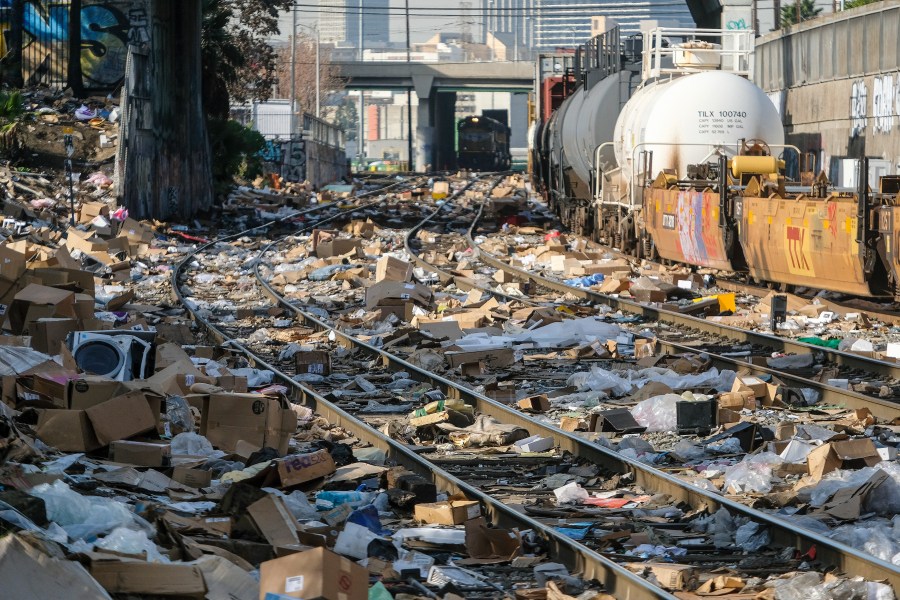 Shredded boxes and packages are seen at a section of the Union Pacific train tracks in downtown Los Angeles Friday, Jan. 14, 2022. Thieves have been raiding cargo containers aboard trains nearing downtown Los Angeles for months, leaving the tracks blanketed with discarded packages. (AP Photo/Ringo H.W. Chiu)