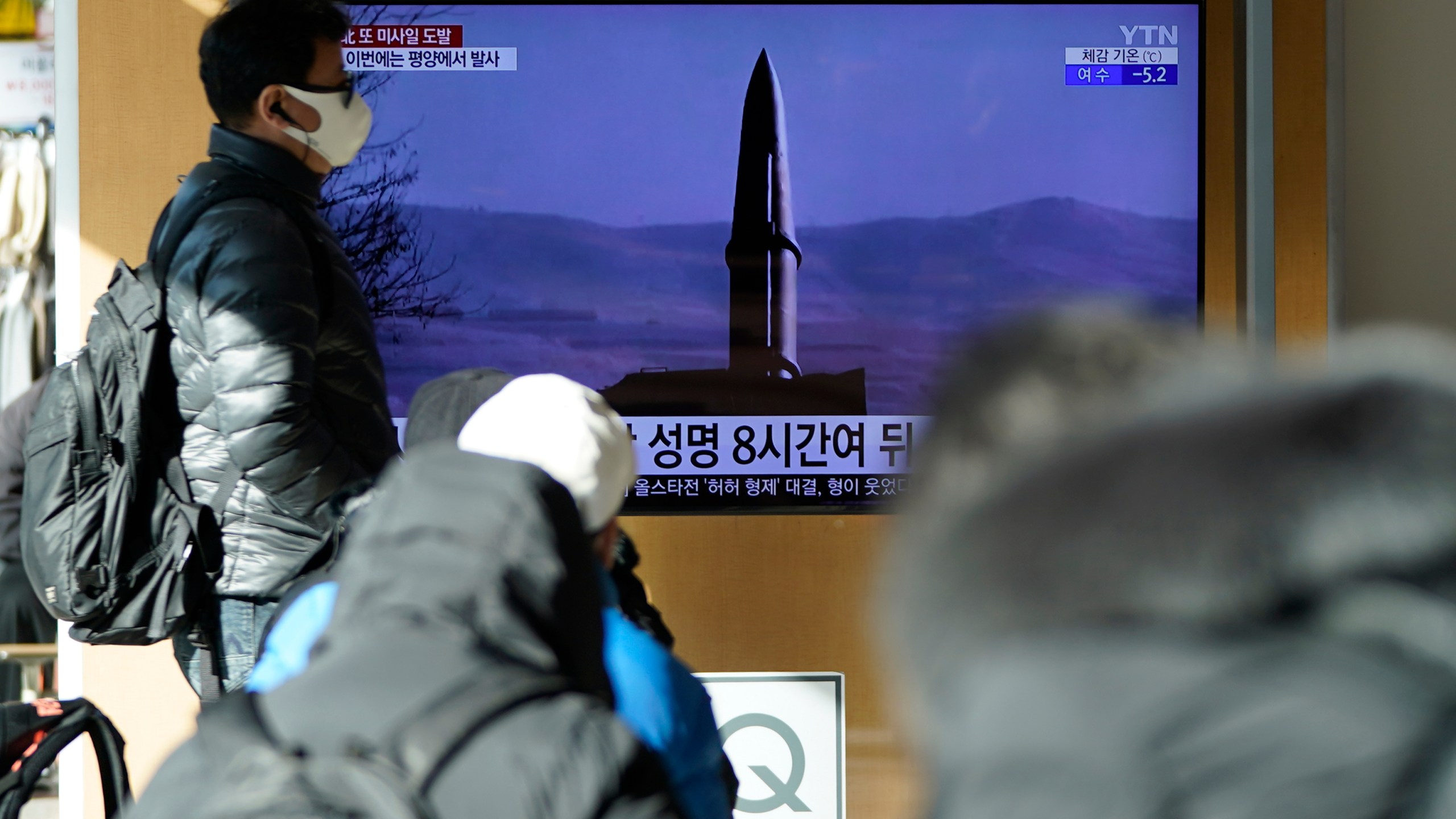 People watch a TV screen showing a news program reporting about North Korea's missile launch with a file image, at a train station in Seoul, South Korea, Monday, Jan. 17, 2022. North Korea on Monday fired two suspected ballistic missiles into the sea in its fourth weapons launch this month, South Korea's military said, with the apparent goal of demonstrating its military might amid paused diplomacy with the United States and pandemic border closures. (AP Photo/Lee Jin-man)