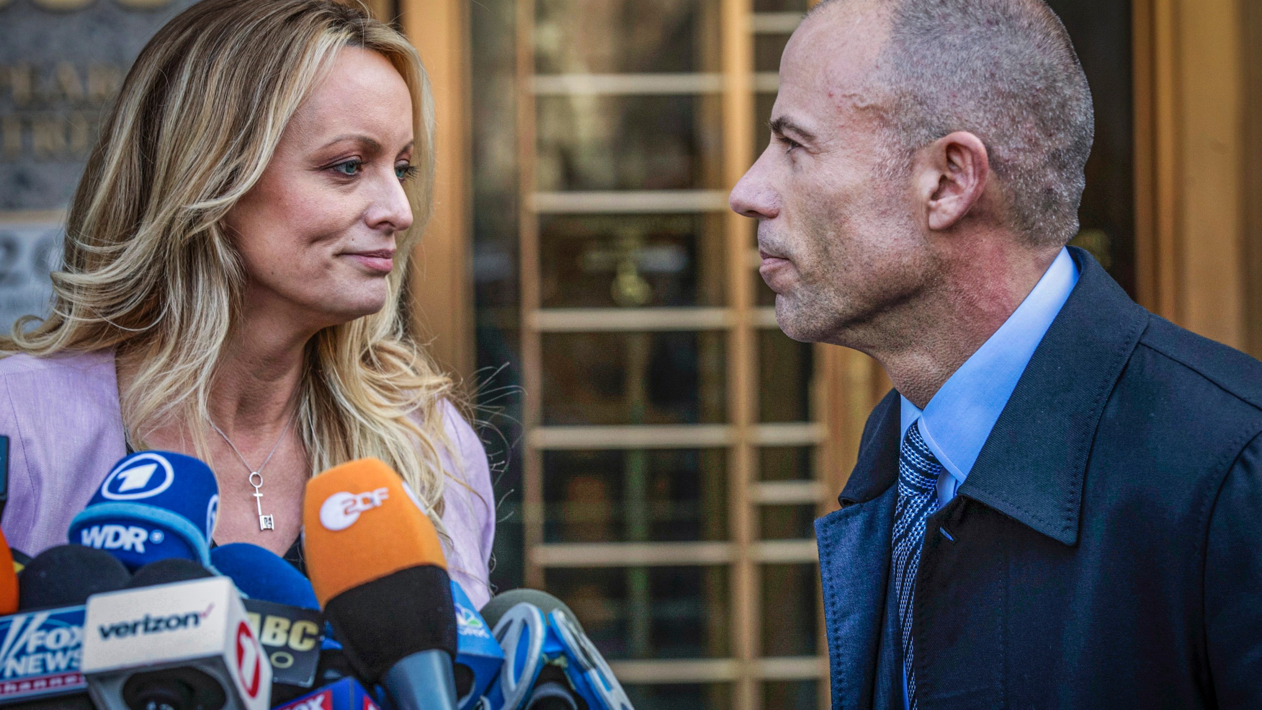 Adult film actress Stormy Daniels, left, stands with her lawyer Michael Avenatti during a news conference outside federal court in New York, April 16, 2018. (AP Photo/Mary Altaffer, File)