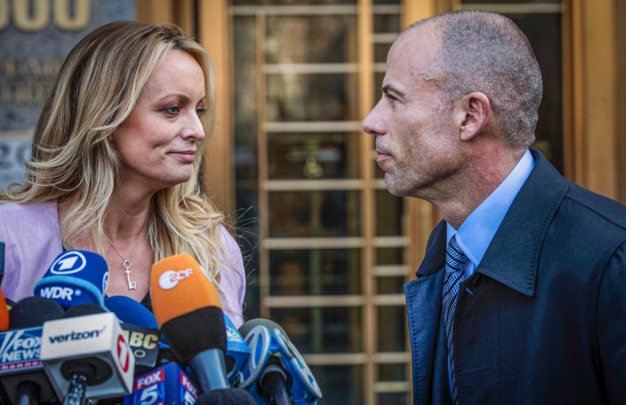 Adult film actress Stormy Daniels, left, stands with her lawyer Michael Avenatti during a news conference outside federal court in New York, April 16, 2018. (AP Photo/Mary Altaffer, File)